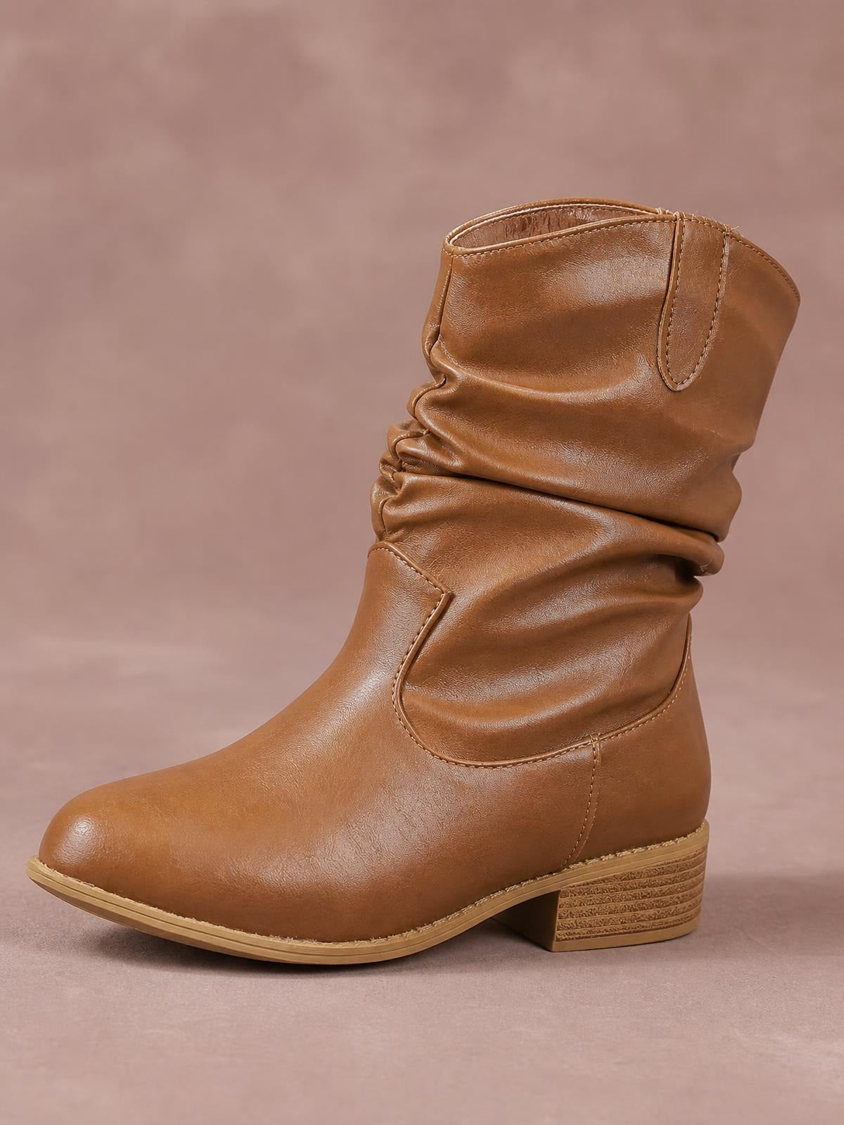Brown mid-calf western boot in smooth PU leather with a slouchy ruched shaft, rounded toe, stitched side panels, and a sturdy block heel.