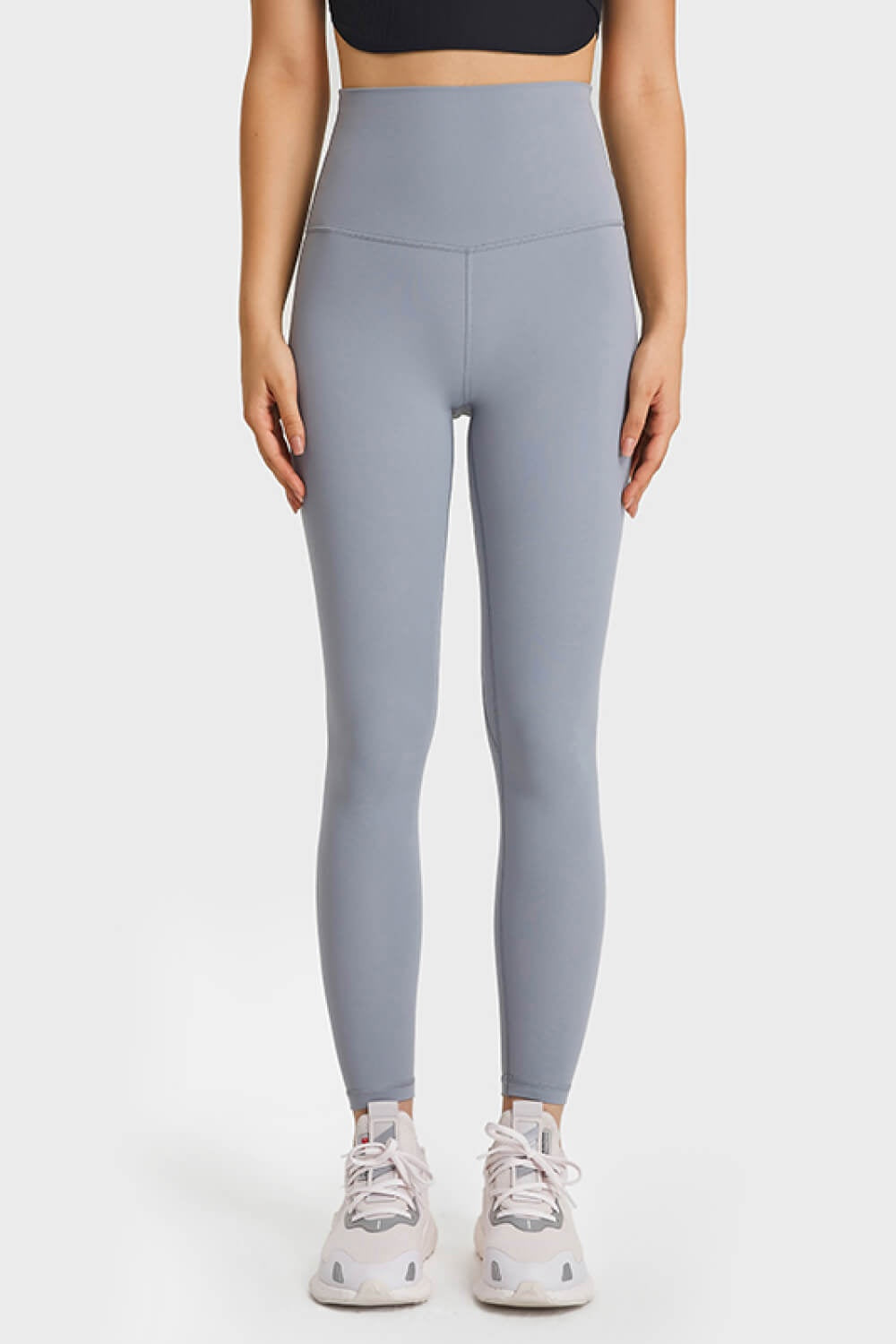 Model stands with hands at her sides wearing solid light gray ultra-soft high waist leggings with a stretchy, close-fitting silhouette and visible seaming.