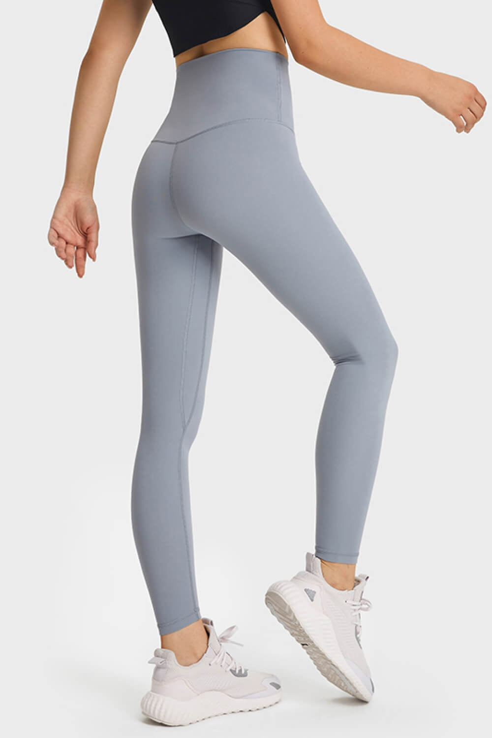 Model in a side pose wears light gray ultra soft high waist leggings with a smooth, stretchy fit, elastic waistband, seamed construction, and ankle-length silhouette.