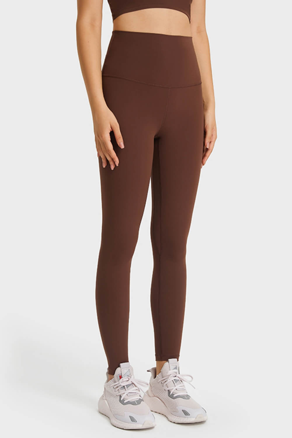 Model wears brown ultra-soft high-waist leggings with an elastic waistband, fitted long-leg silhouette, and visible center seam.