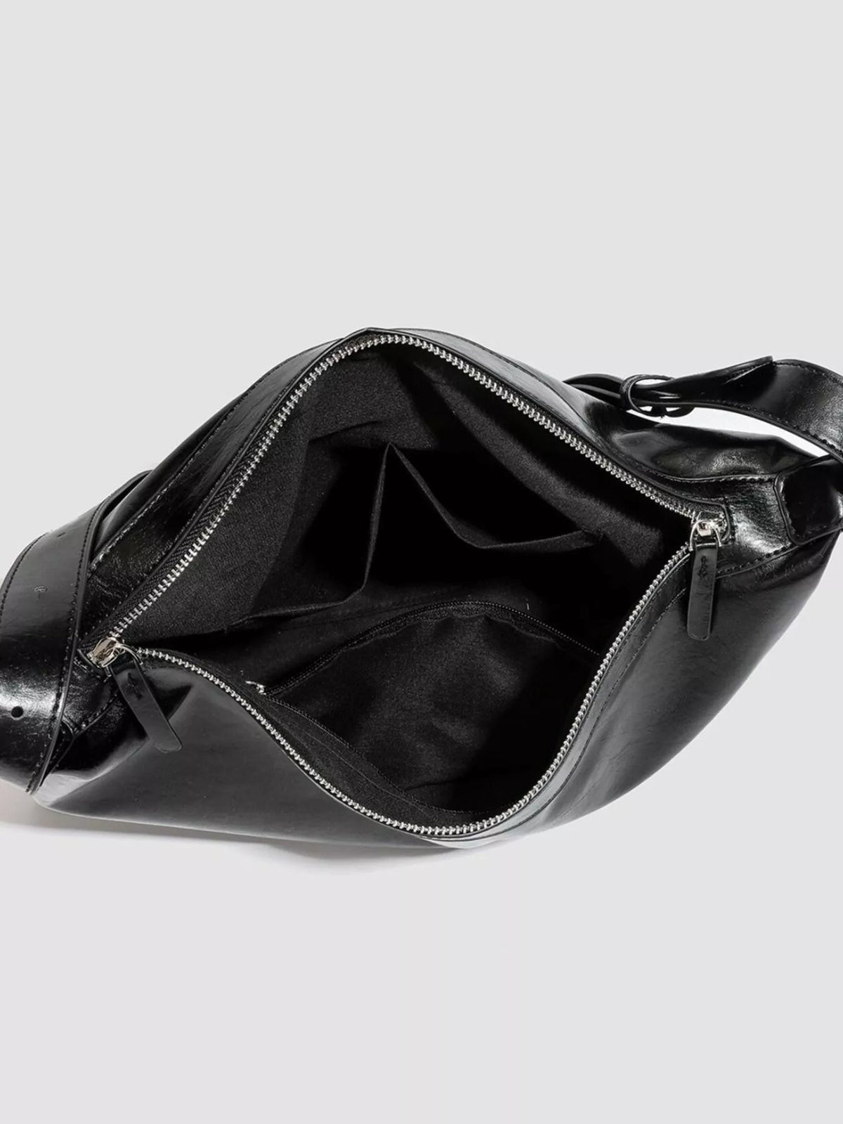 Open black glossy PU leather slouchy shoulder bag with a medium silhouette, spacious interior, zip closure, and multiple inner compartments.