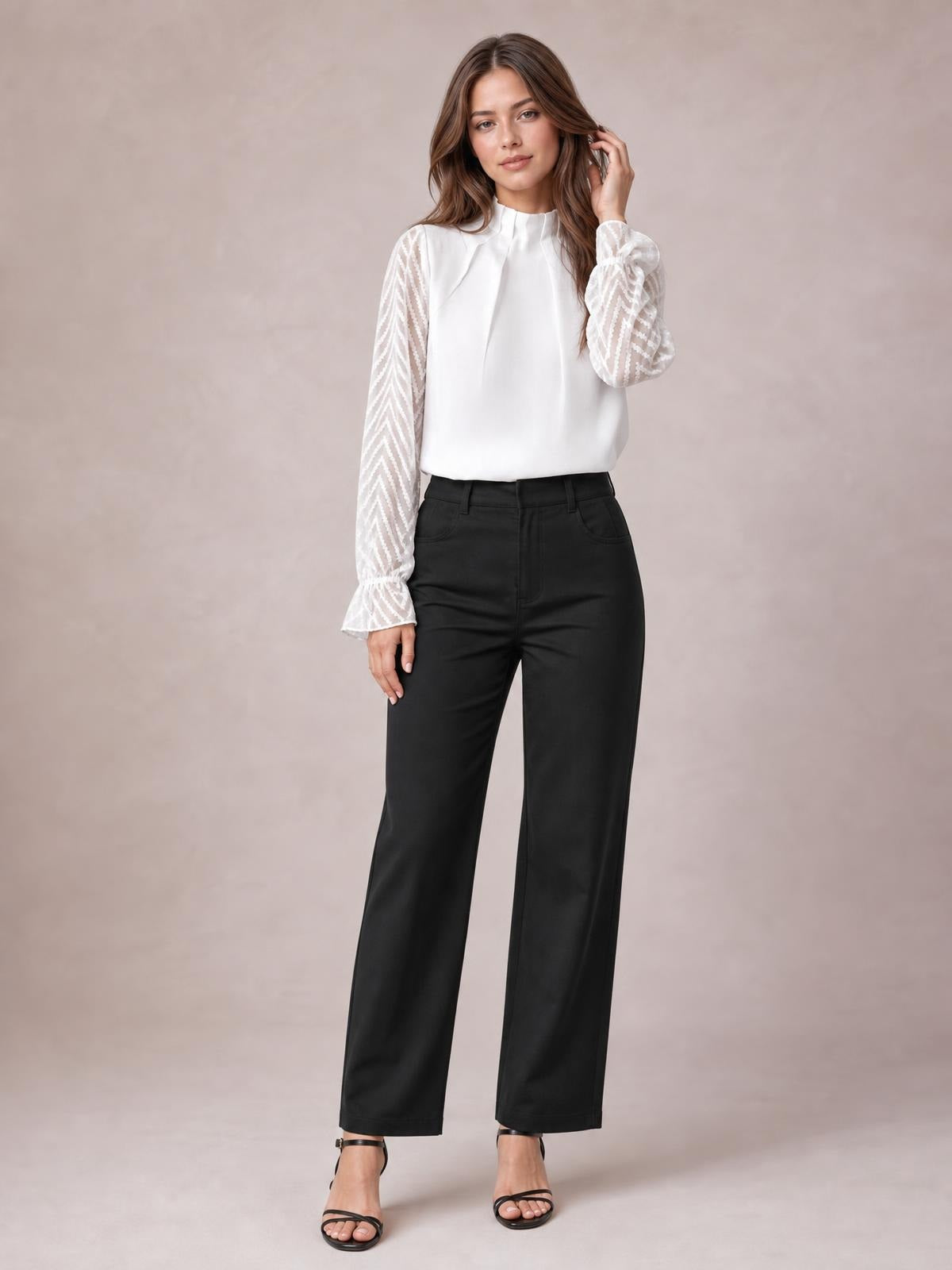 A model stands in a white mock neck blouse with a relaxed silhouette, sheer patterned flounce sleeves, ruffled cuffs, and one hand touching her hair.