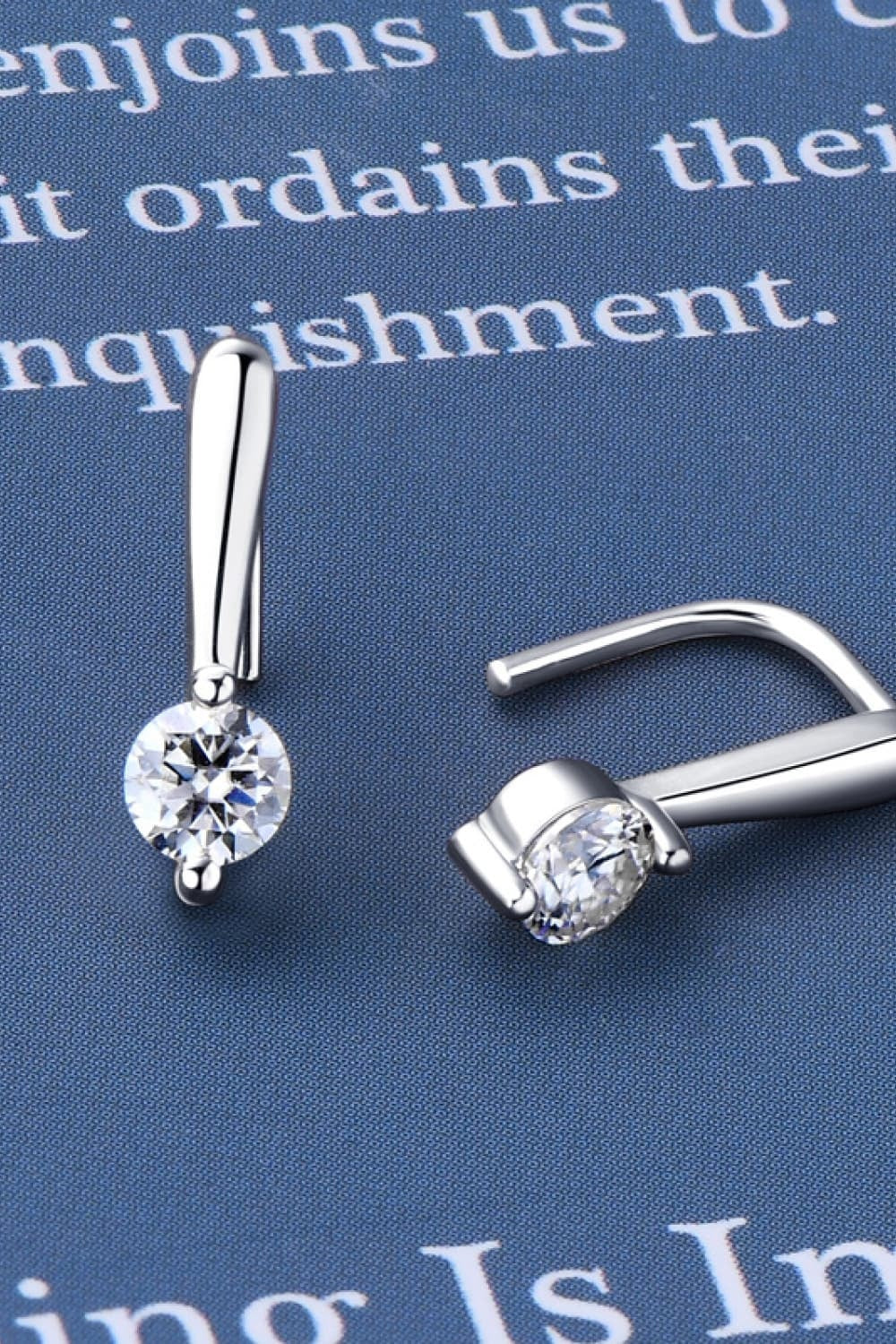Pair of 925 sterling silver moissanite earrings with polished elongated bar settings and round brilliant stones in a sleek, elegant drop silhouette.