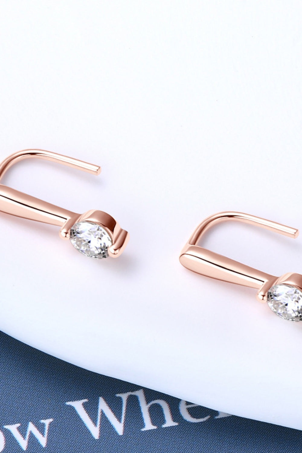 Rose gold-plated 925 sterling silver earrings feature brilliant round moissanite stones in sleek curved hook settings for an elegant, polished finish.