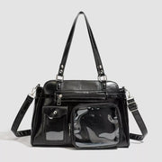 Black medium PU leather shoulder bag with top handles, a detachable strap, multiple zip and flap pockets, and a large clear window pocket.