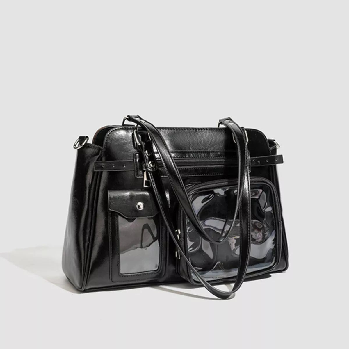 Black medium PU leather shoulder bag with a structured silhouette, multiple pockets, twin top handles, a long strap, and a clear front window.