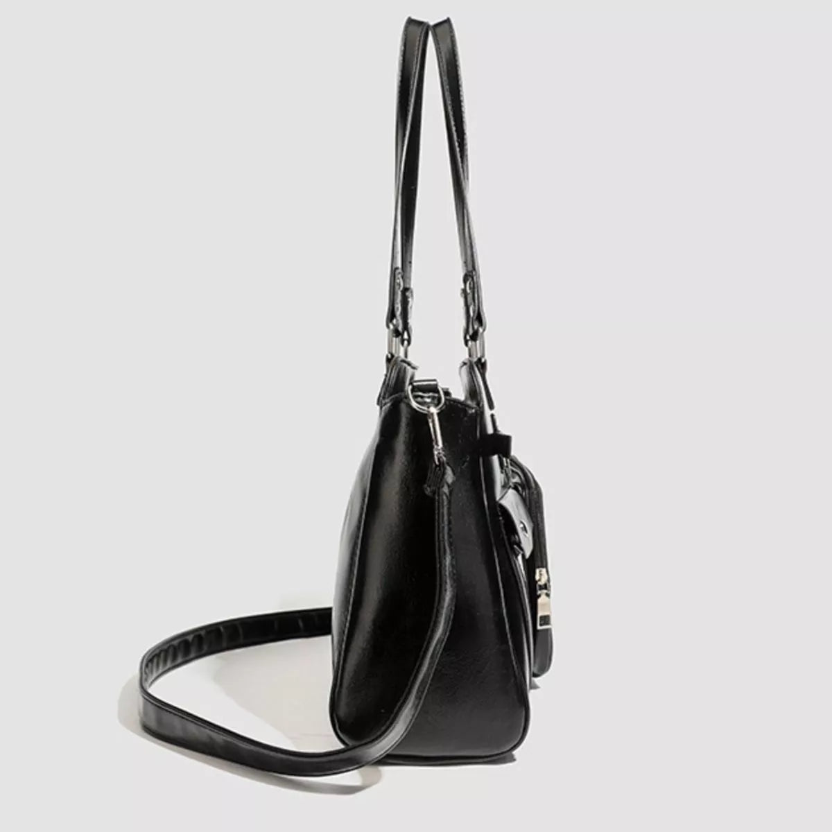 Black PU leather medium shoulder bag with a structured silhouette, long adjustable strap, side zip pocket, and silver-tone hardware.