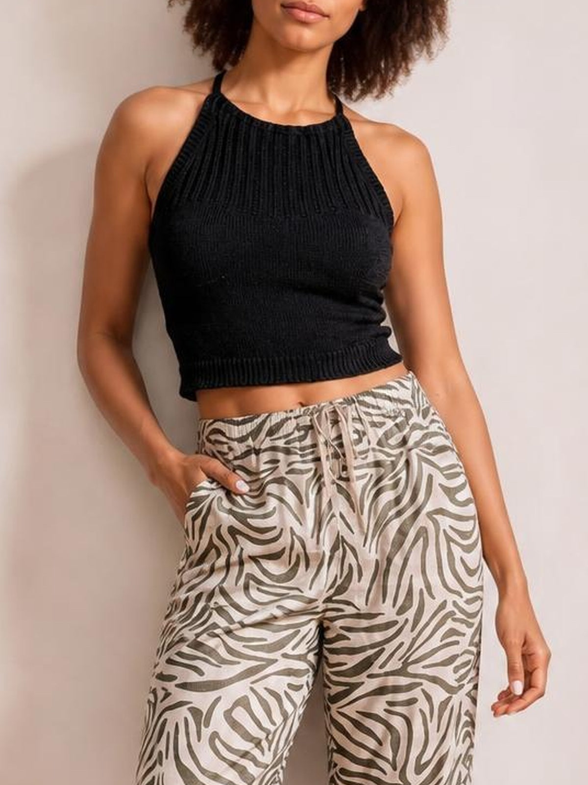 Model wearing multicolour zebra-pattern pants with a relaxed wide-leg silhouette, elastic drawstring waist, and visible side pockets.
