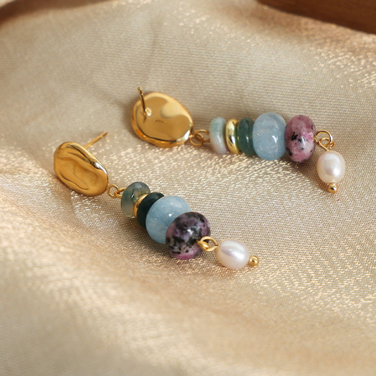 Natural stone freshwater pearl dangle earrings feature gold-toned oval studs, colorful rounded stone beads, and polished white pearl drops in an elegant silhouette.
