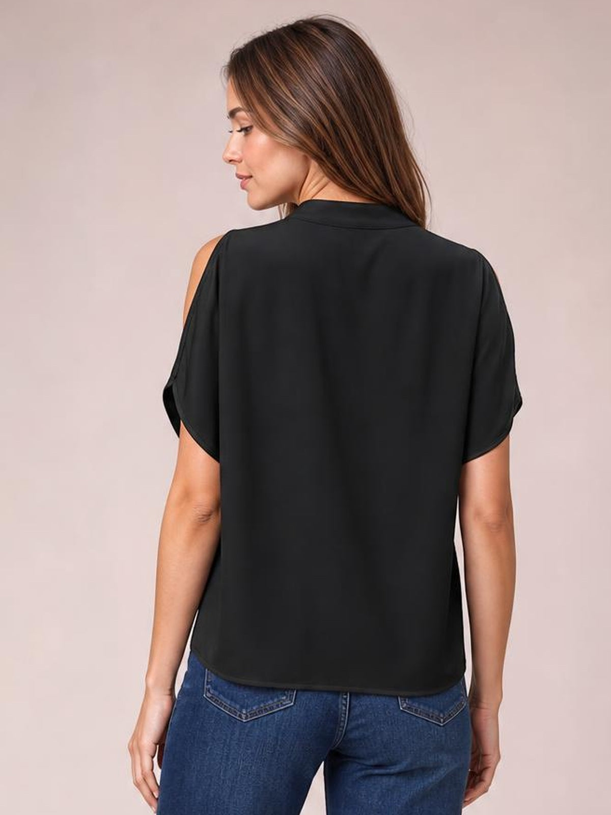 Model shown from the back wearing a black notched cold shoulder blouse with a relaxed straight silhouette, short sleeves, and curved hem.