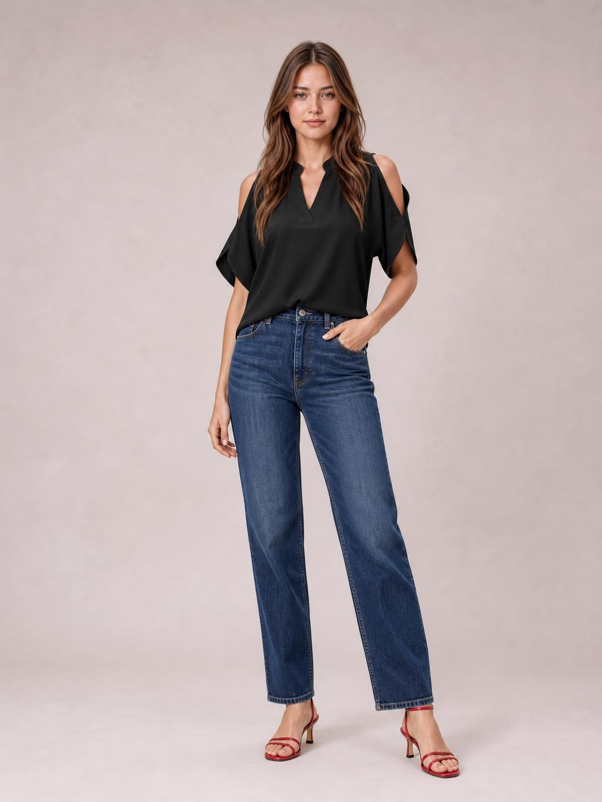 A model wears a black Notched Cold Shoulder Blouse with a V neckline, shoulder cutouts, short sleeves, and a relaxed, fluid silhouette.