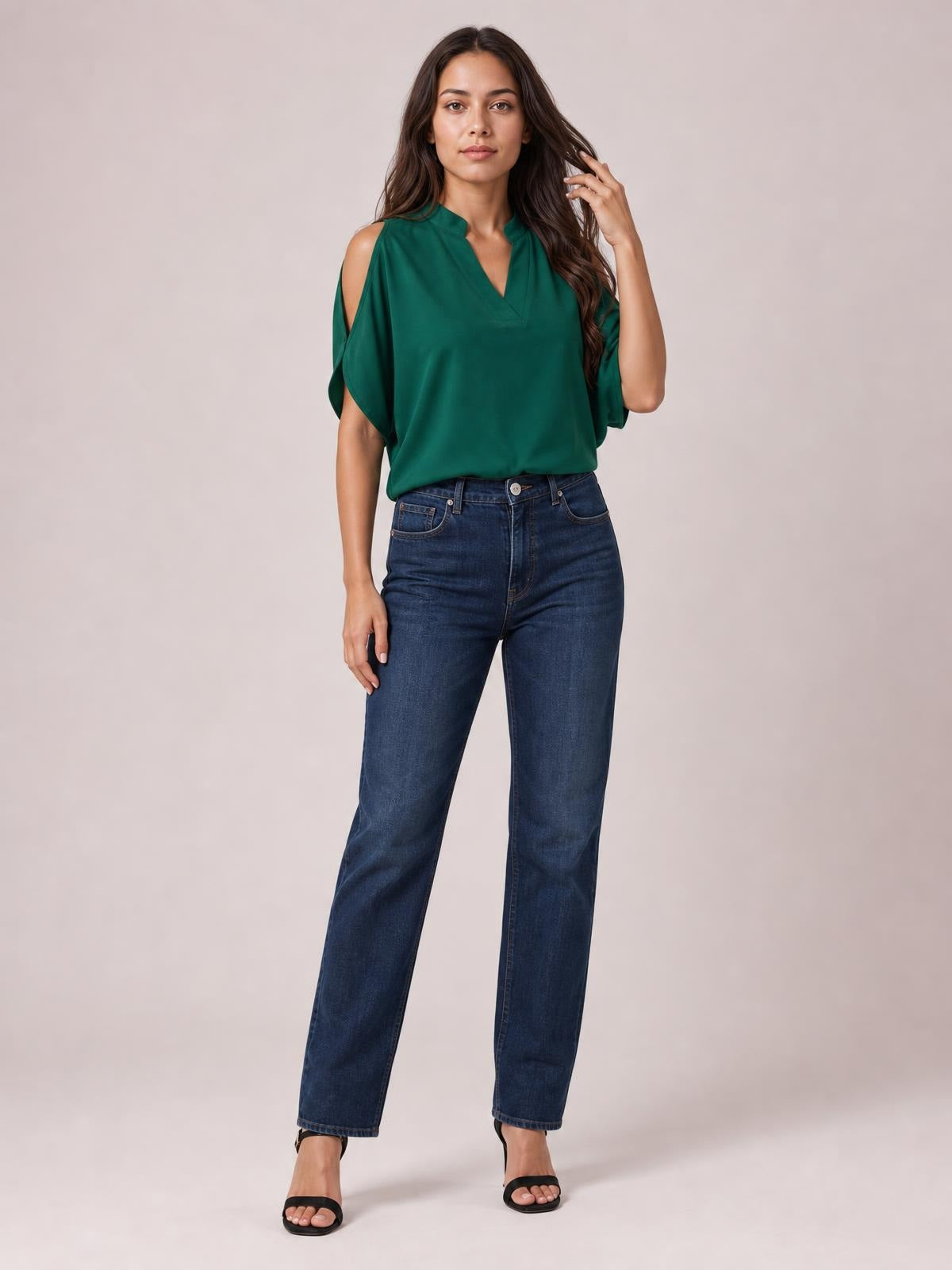 A model poses in a deep green notched cold shoulder blouse with shoulder cutouts, a relaxed draped silhouette, and loose short sleeves.