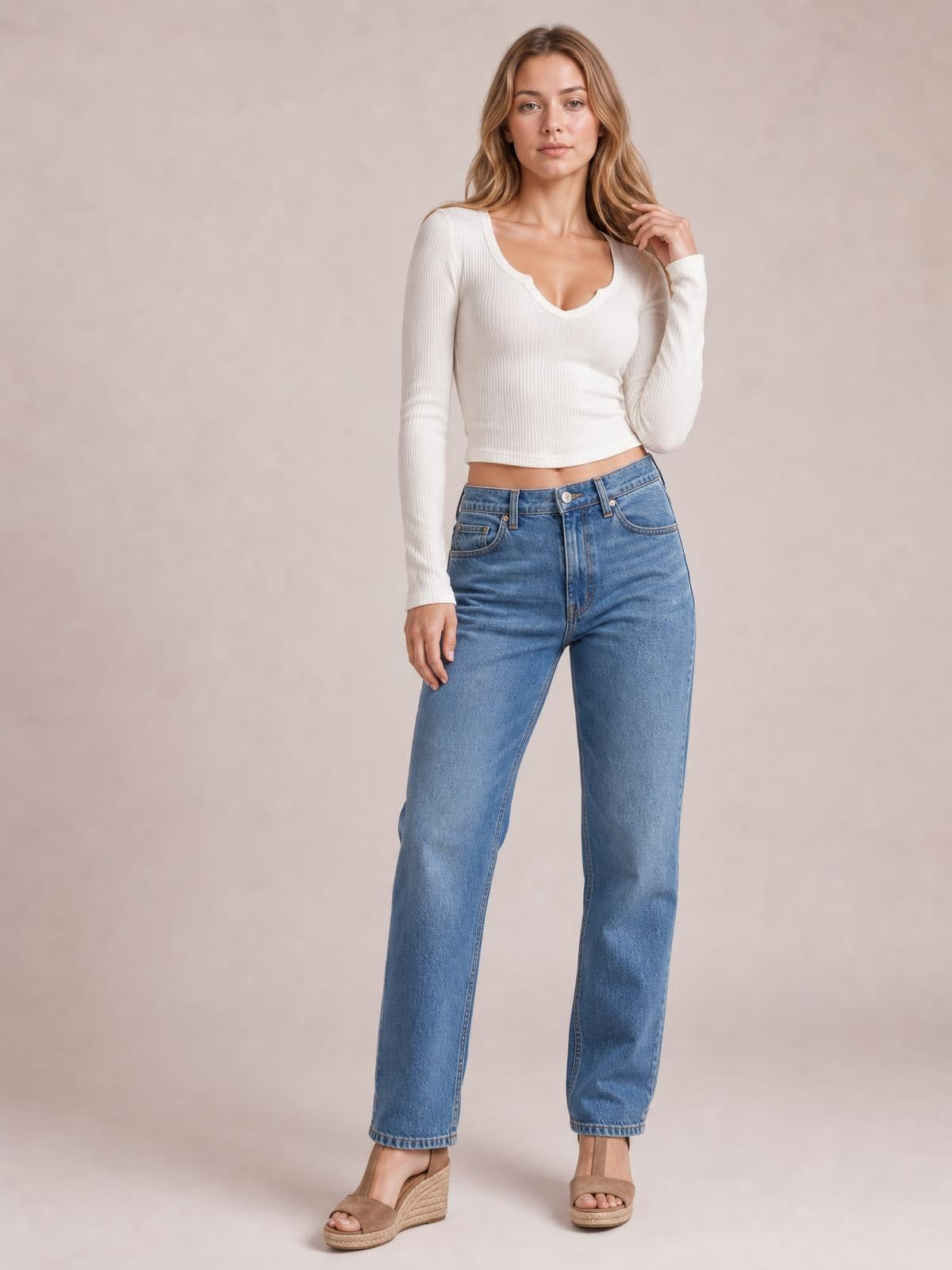 Model wears a white notched long sleeve T-shirt with a ribbed texture, scoop neckline, fitted cropped silhouette, and slightly stretchy construction.