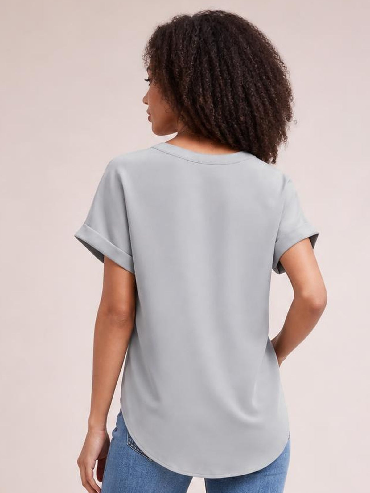 Model shown from the back wearing a solid light gray Notched Neck Cuffed Sleeve Shirt with a relaxed regular-length silhouette and rolled short sleeves.