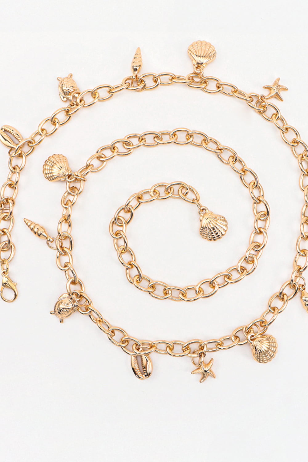 Warm gold-tone Ocean Element Charm Chain Belt with open linked-chain construction and dangling shell, starfish, and coastal charms.