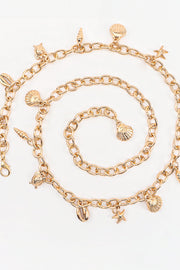 Warm gold-tone Ocean Element Charm Chain Belt with open linked-chain construction and dangling shell, starfish, and coastal charms.
