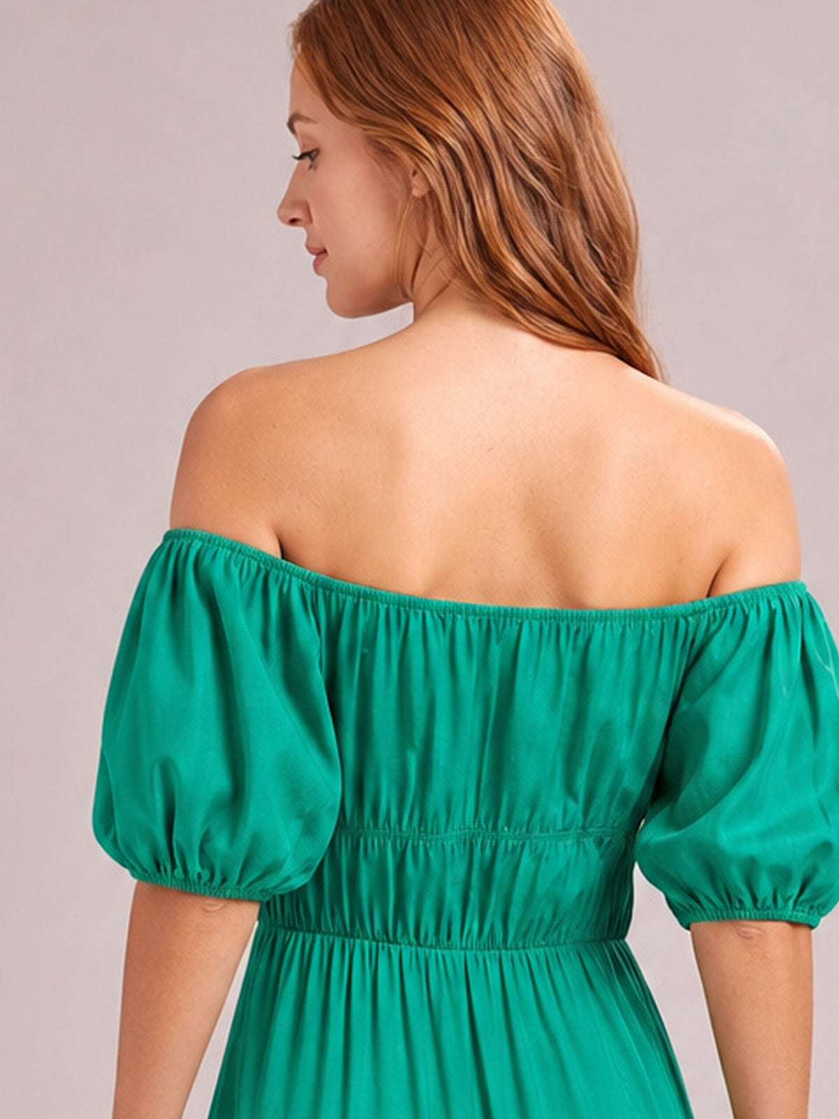 Model shown from behind in a vibrant teal off-shoulder midi dress with voluminous half-length puff sleeves, gathered waist, and softly draped construction.