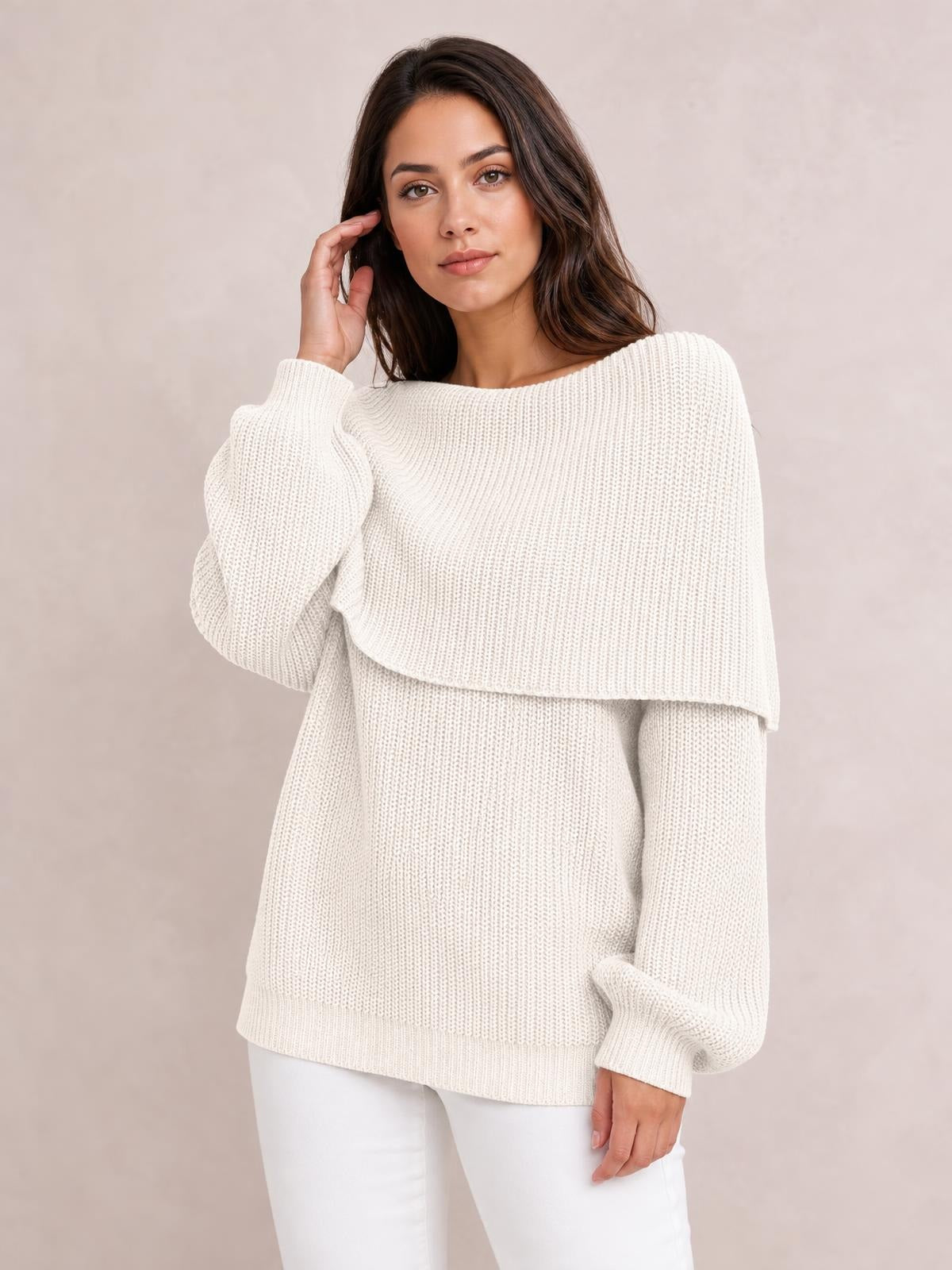 Model wearing an ivory off-shoulder long sleeve sweater with an oversized silhouette, ribbed knit texture, dropped shoulders, and ribbed cuffs.