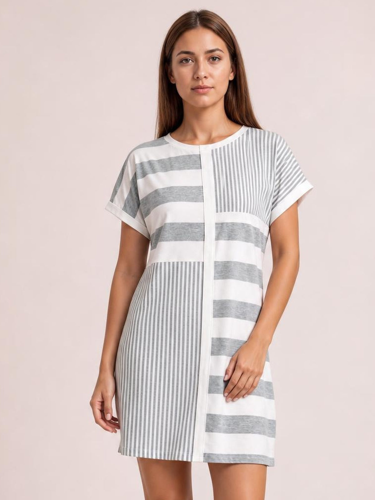 Model wearing a gray and white striped round-neck short-sleeve mini tee dress with a relaxed straight silhouette and contrasting horizontal and vertical stripes.