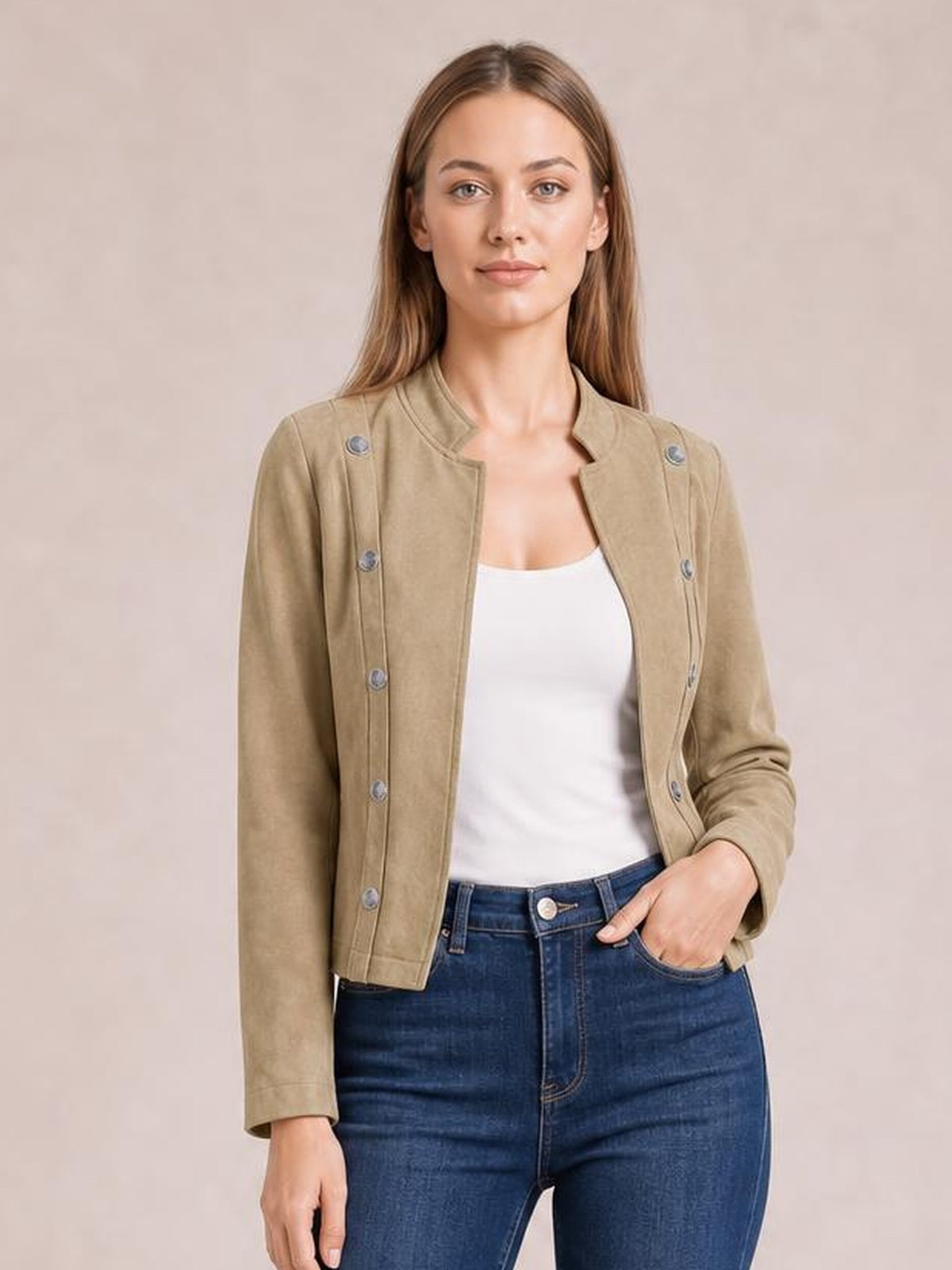 A model poses front-facing in a tan open-front cropped jacket with long sleeves, visible buttons, a structured silhouette, and a short stand collar.