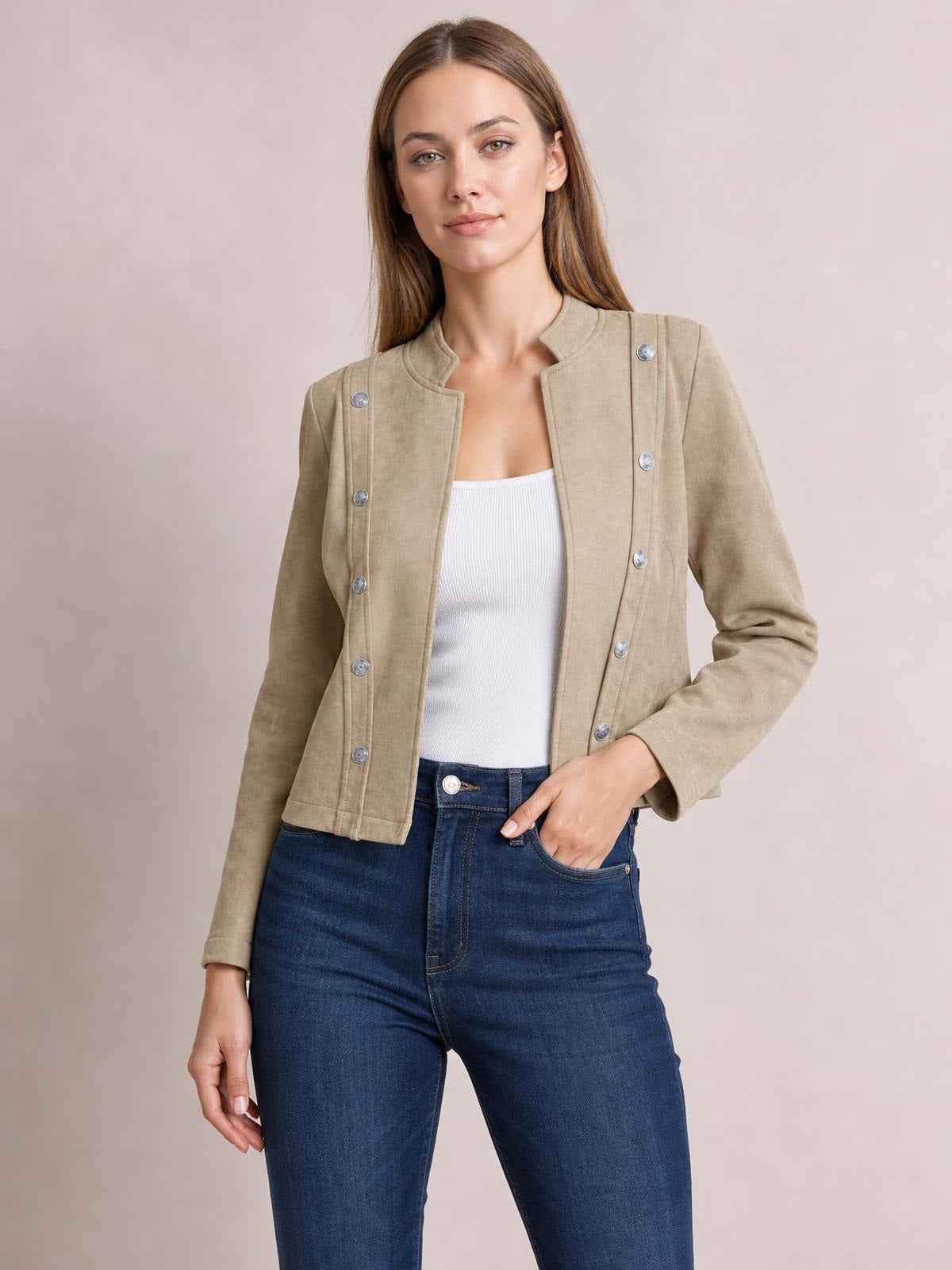 A model poses in a taupe open-front cropped jacket with long sleeves, a structured stand collar, silver button detailing, and a streamlined fitted silhouette.