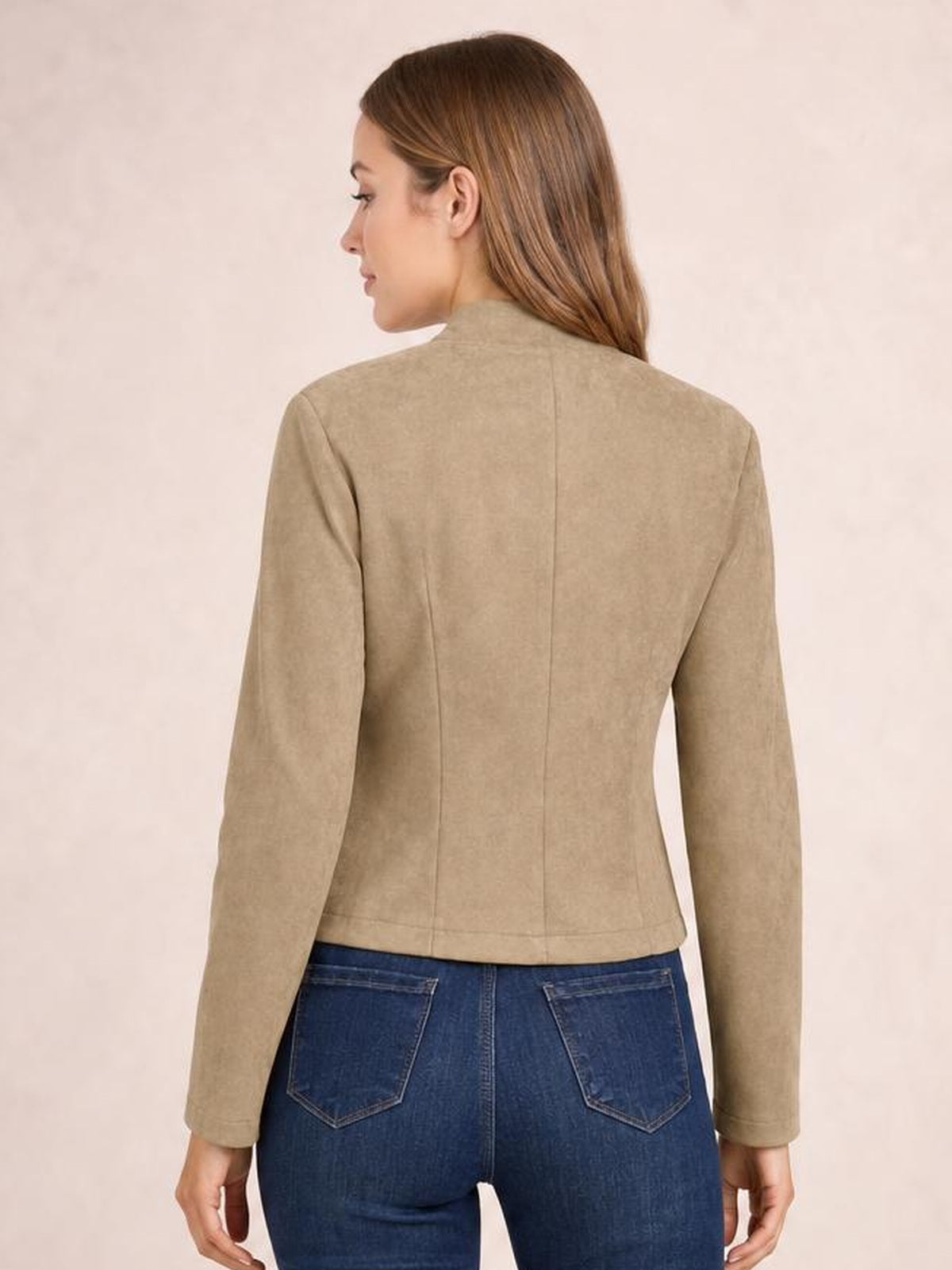 Model shown from behind wearing a tan cropped jacket with long sleeves, a fitted silhouette, high neckline, and visible center-back and waist seams.