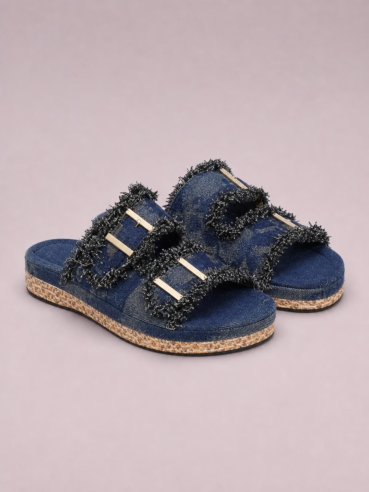 Navy open-toe platform sandals feature double gold buckles, black frayed trim, textured cloth uppers, and cork-look flat soles.