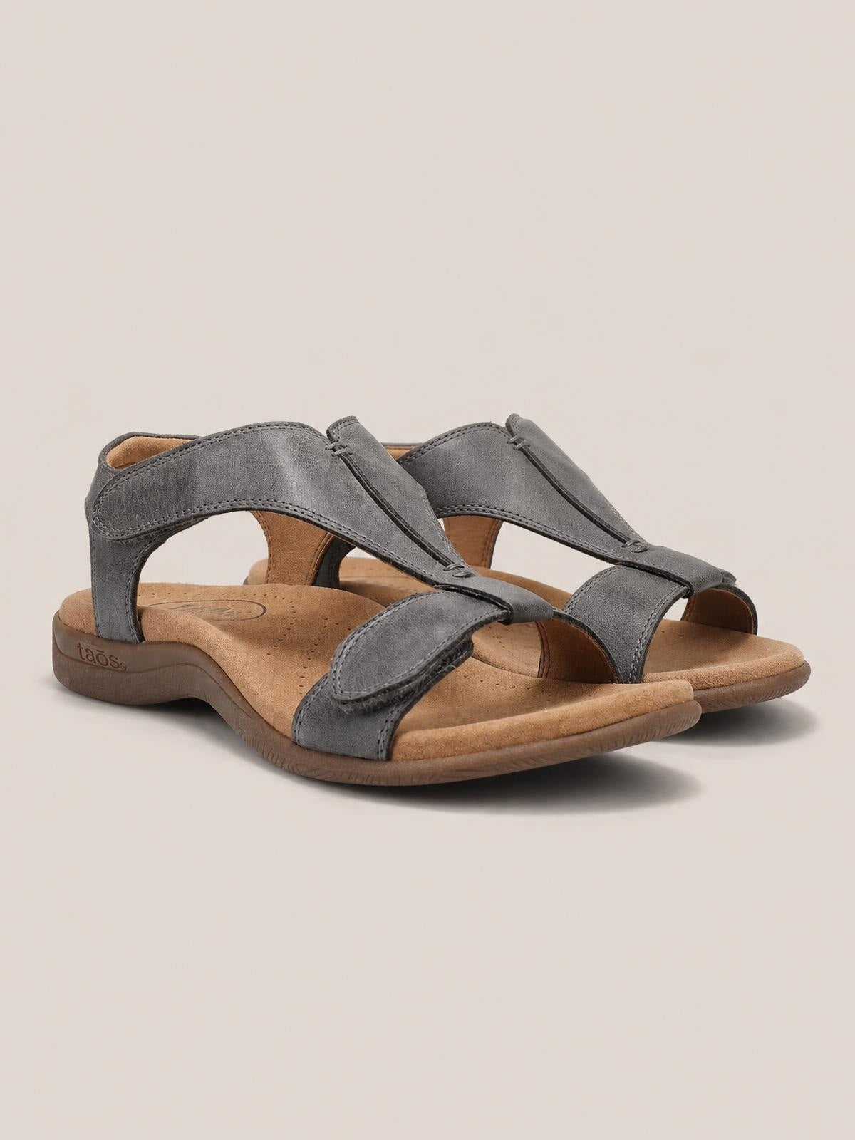 Gray open-toe flat sandals in textured PU leather feature layered adjustable straps, tan cushioned footbeds, and flexible rubber soles.