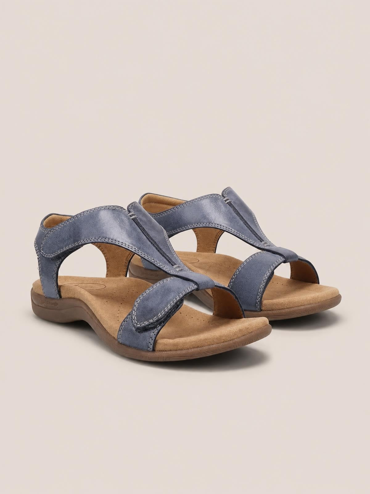 Blue PU leather open toe flat sandals with stitched crossover straps, cushioned footbeds, adjustable heel straps, and durable rubber soles.