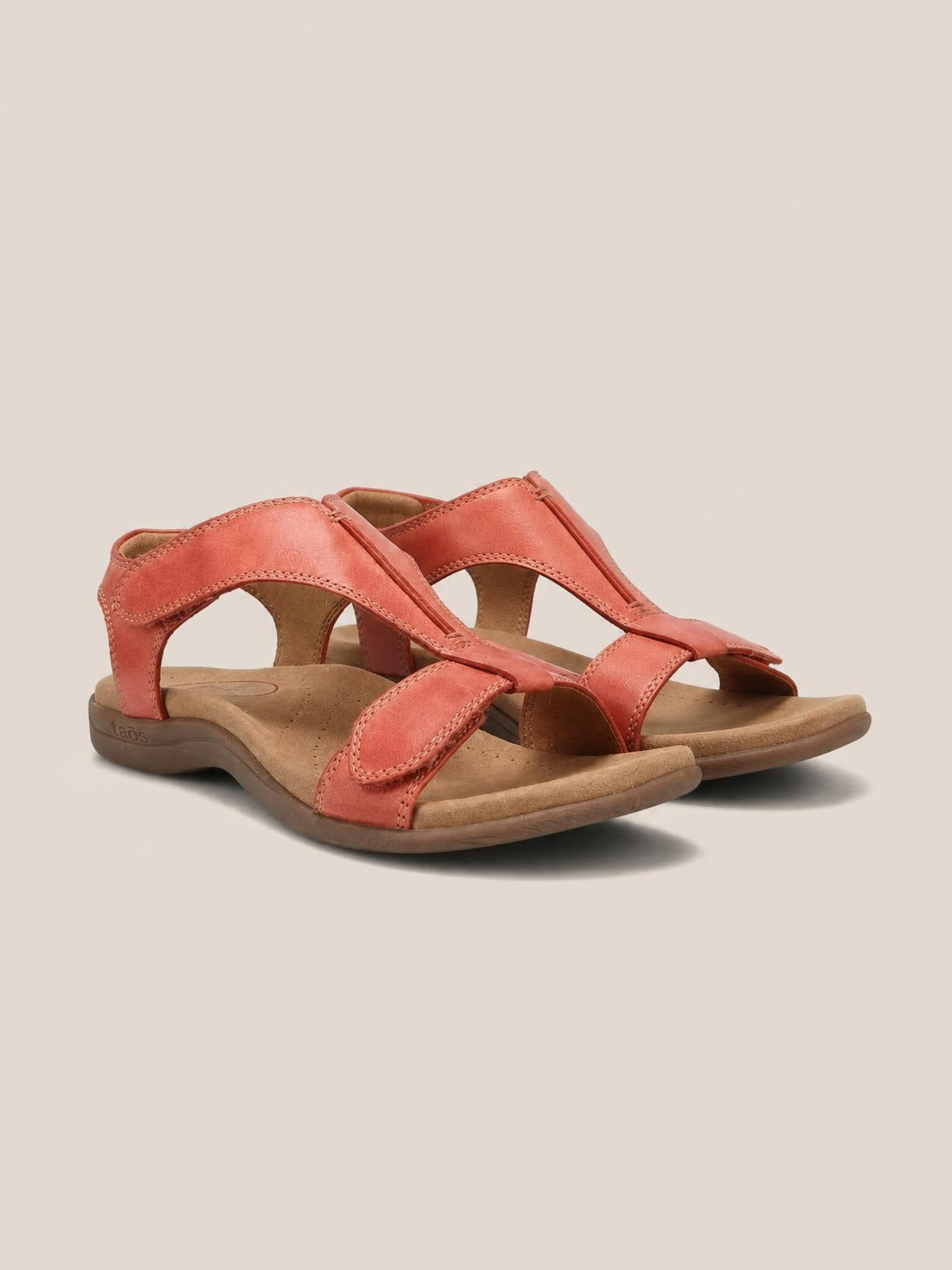 Coral open toe flat sandals in PU leather feature wide stitched straps, adjustable ankle closures, cushioned footbeds, and durable rubber soles.