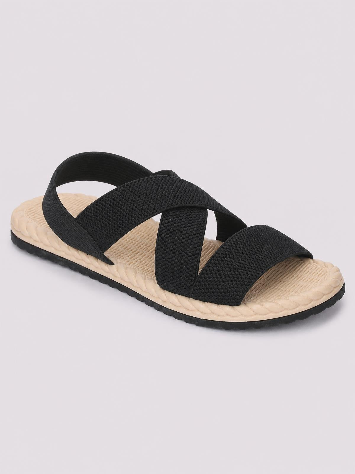 Black open toe flat sandal with textured crossover straps, a woven beige footbed, and a durable black rubber outsole.