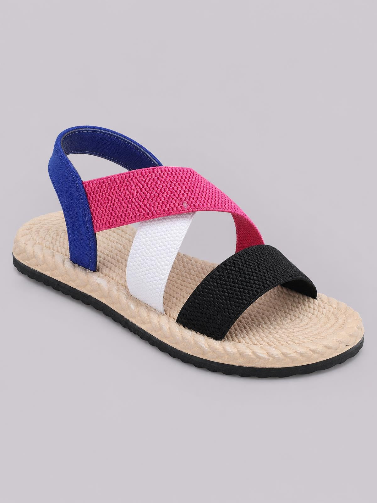 Open-toe flat sandal with textured black, pink, white, and blue straps, a woven beige footbed, and a durable black rubber outsole.