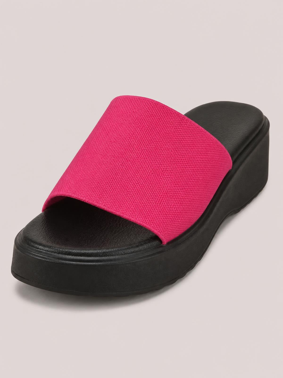Hot pink cloth open-toe platform sandal with a wide textured strap, cushioned footbed, and thick black rubber flat sole.