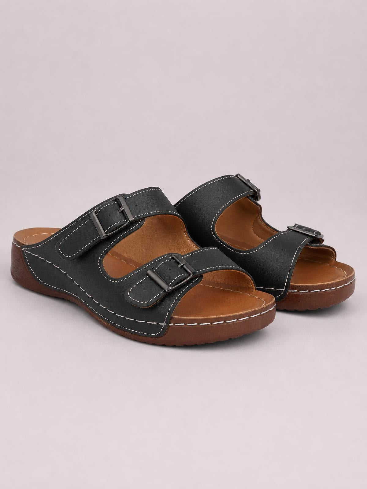 Black open toe platform sandals with adjustable buckled straps, contrast stitching, cushioned brown footbeds, and thick flat rubber soles.