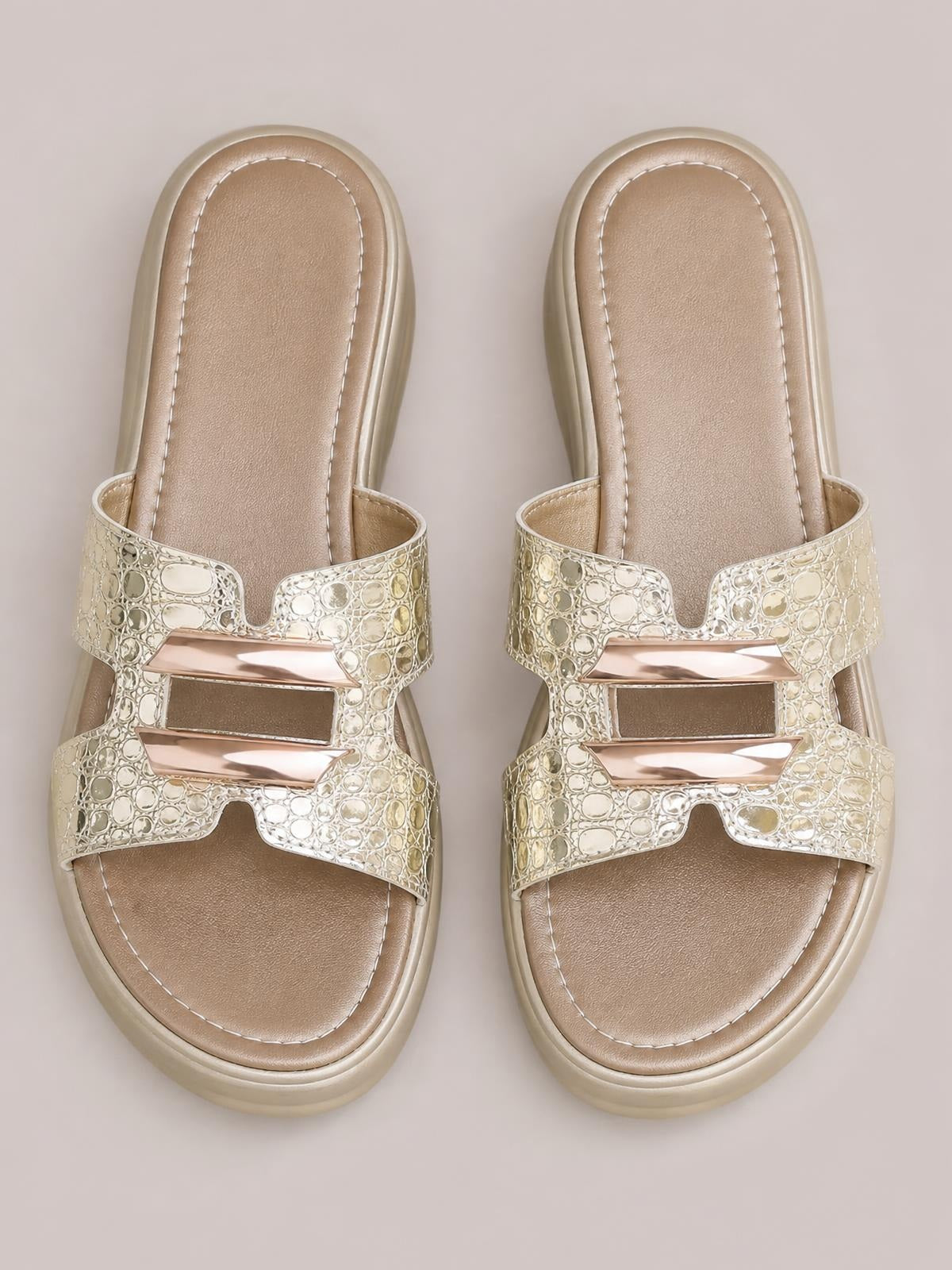 Metallic gold open-toe platform wedge sandals feature textured cutout straps, cushioned stitched footbeds, and mid-height wedge soles.