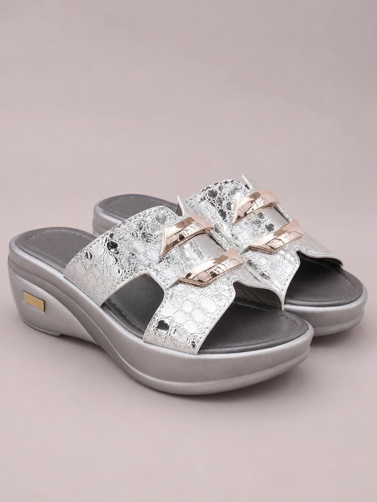 Silver open-toe platform wedge sandals with textured crossover straps, metallic buckles, cushioned footbeds, and mid-height wedge heels.