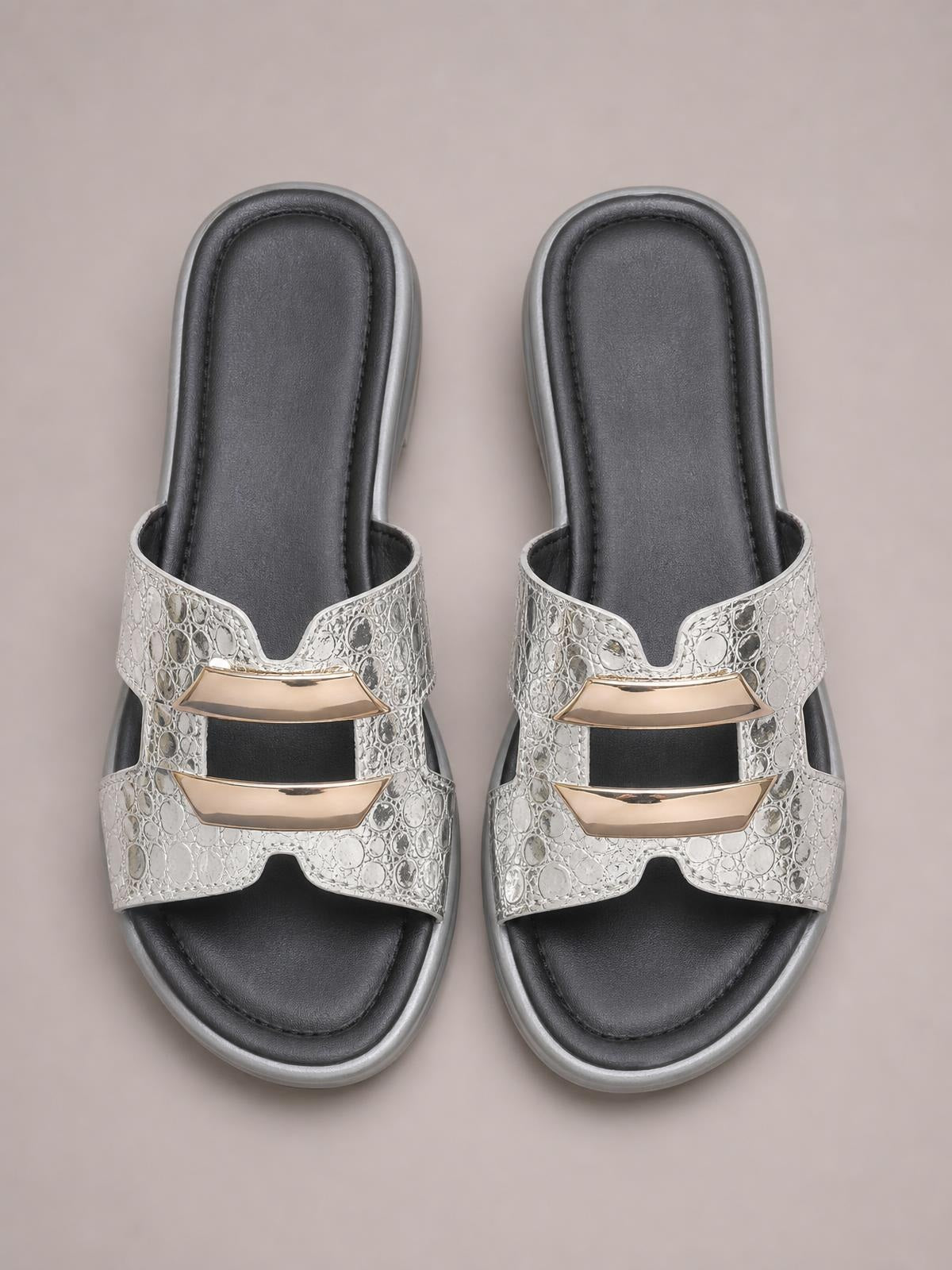 Silver open-toe platform wedge sandals feature textured double straps with gold-tone accents, black cushioned footbeds, and contrasting gray soles.