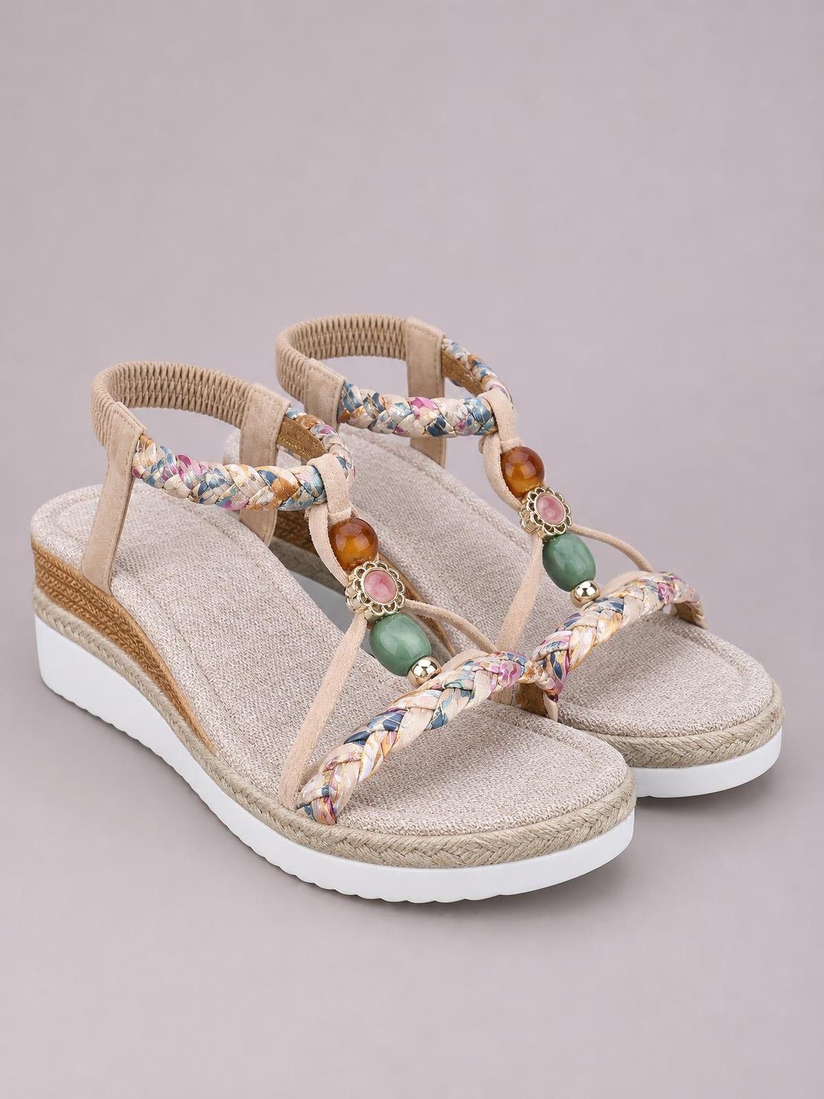 Beige open-toe platform wedge sandals with braided multicolor straps, beaded accents, rope-textured trim, and a white EVA sole.