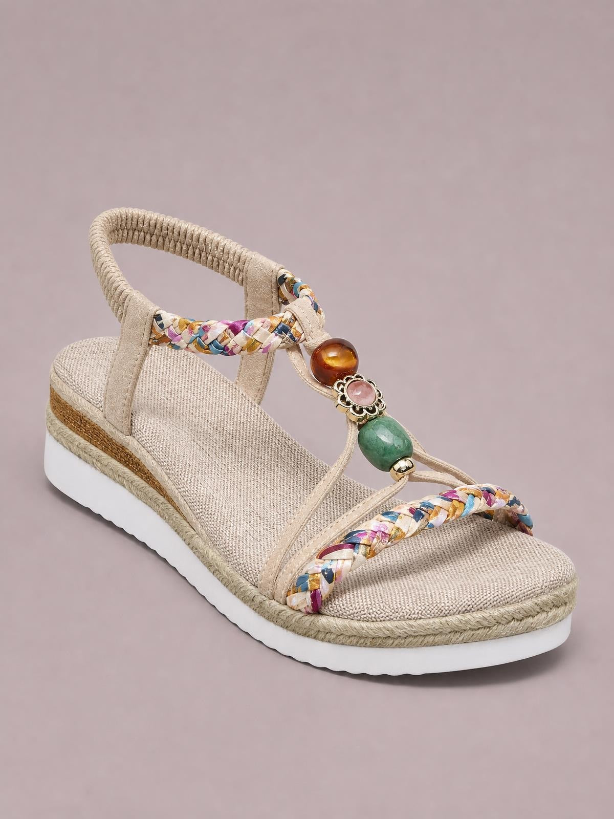 Beige open-toe platform wedge sandals feature multicolor braided straps, a beaded center accent, ankle strap, textured footbed, and layered espadrille-style sole.