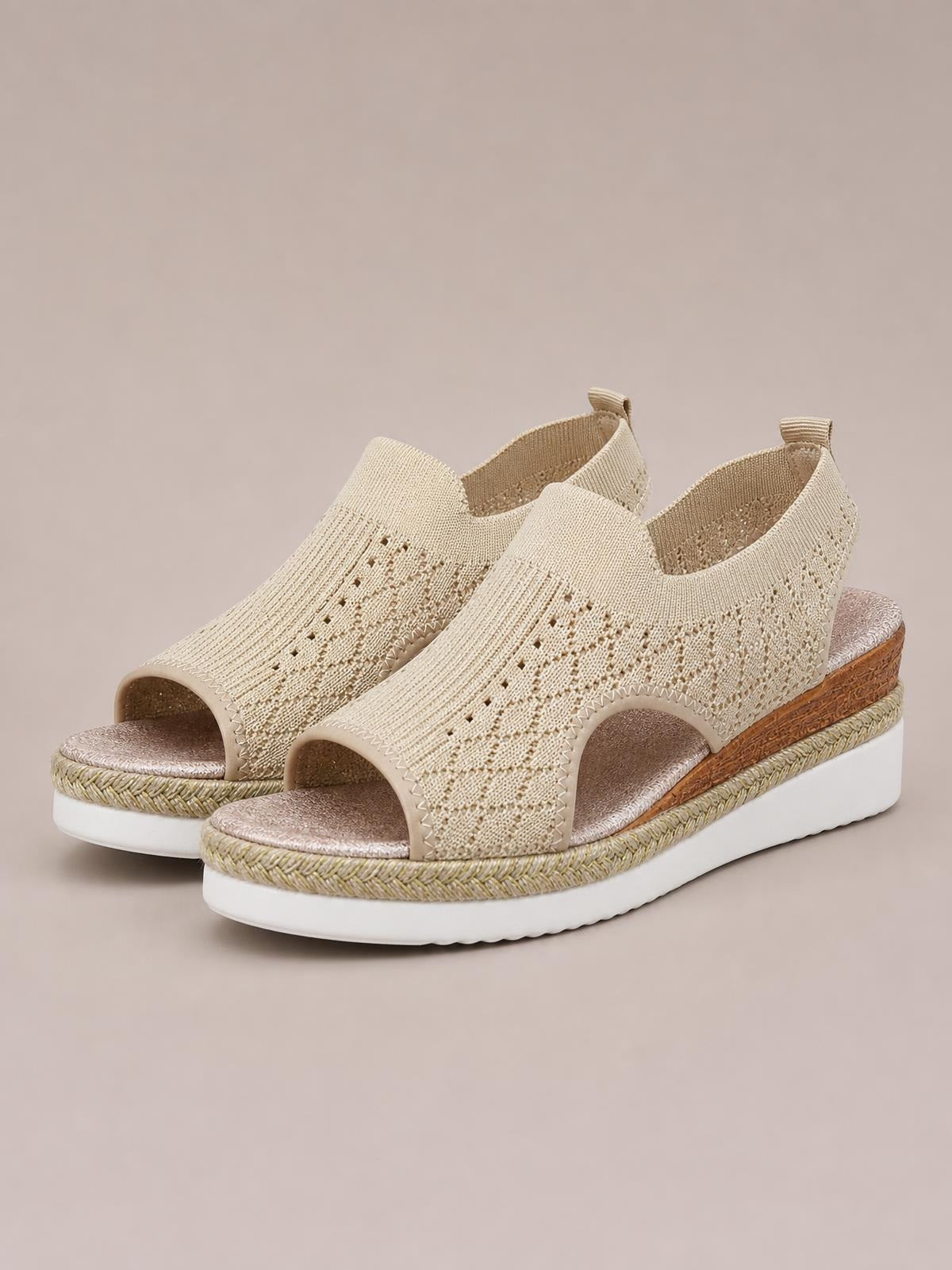 Beige open toe platform wedge sandals feature breathable mesh uppers, side cutouts, cushioned footbeds, and textured midsoles with mid-height heels.