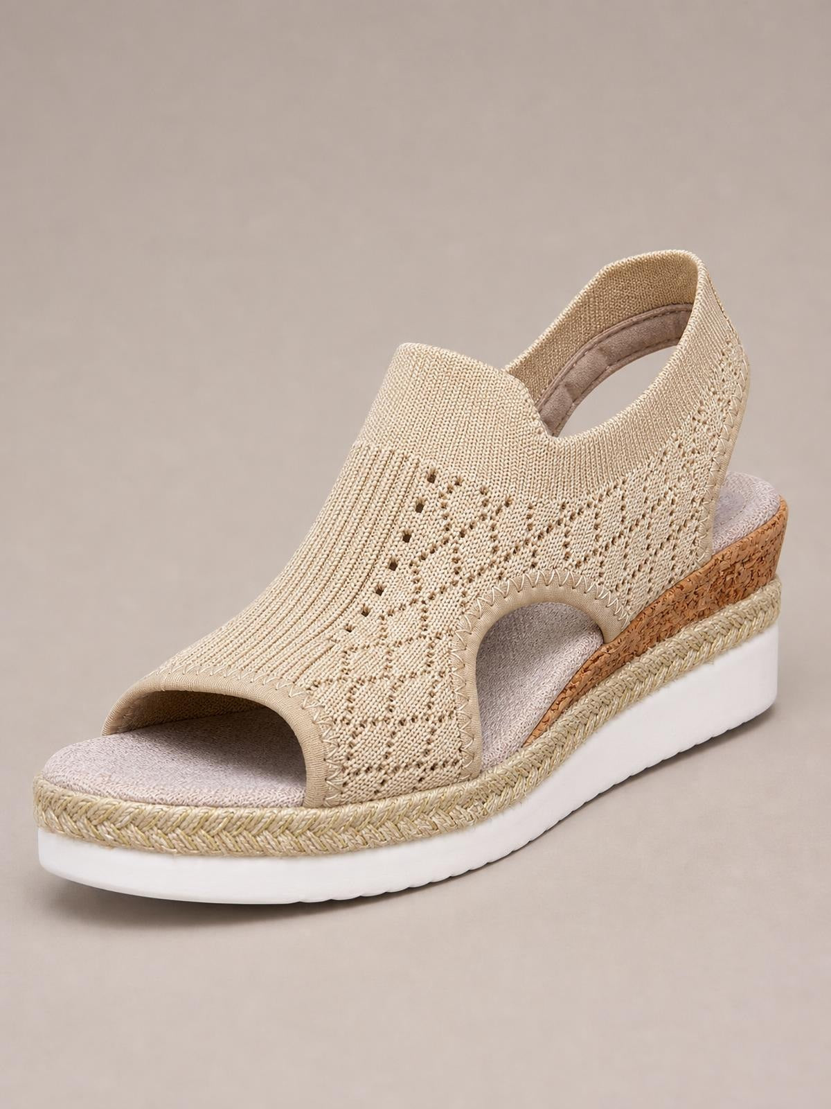 A beige mesh open toe platform wedge sandal features a perforated upper, ankle strap, espadrille-style trim, and a white rubber mid-height sole.