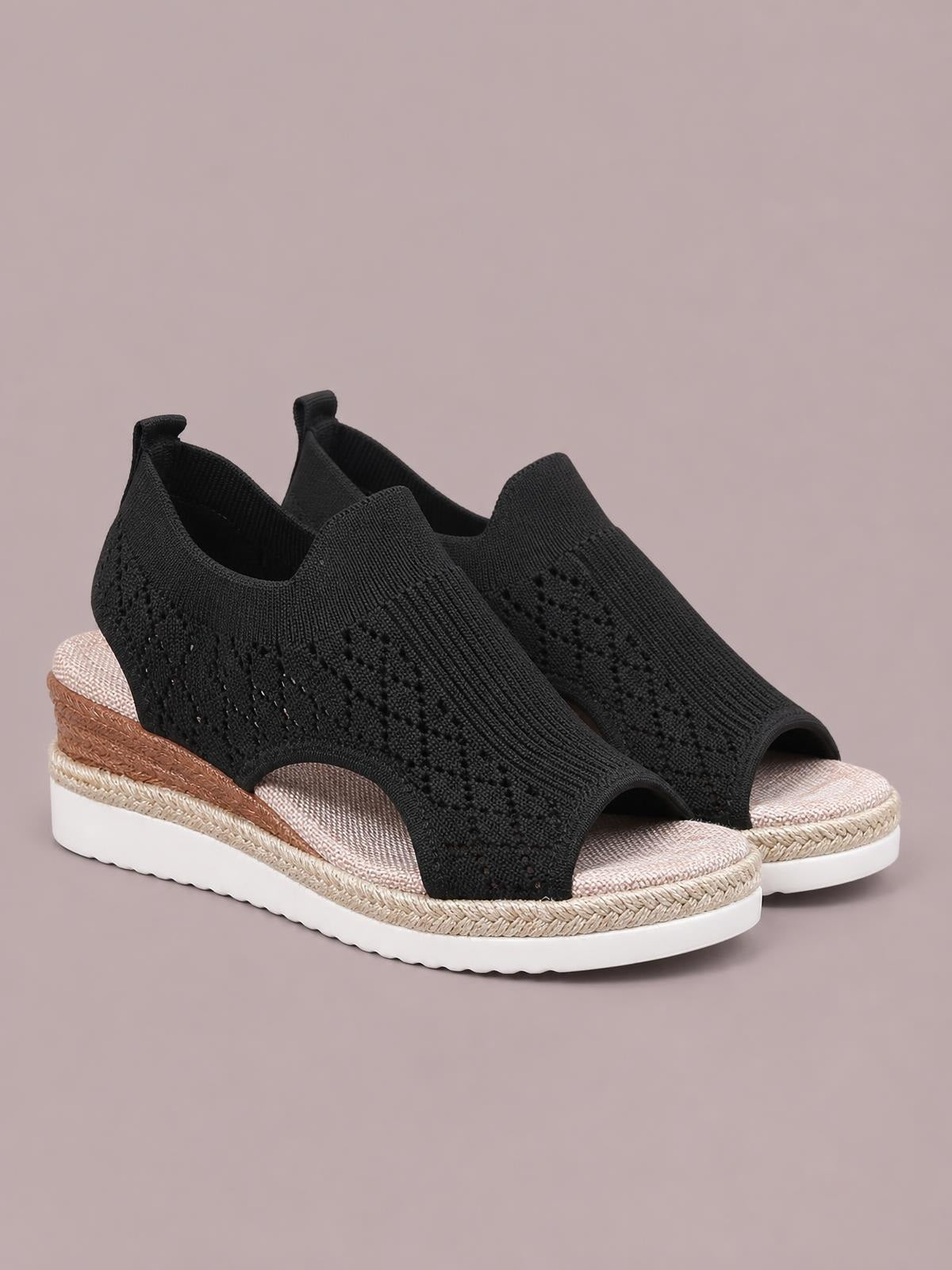 Black mesh open toe platform wedge sandals feature a mid-height wedge, textured woven upper, rope-trimmed sole, and white rubber outsole.