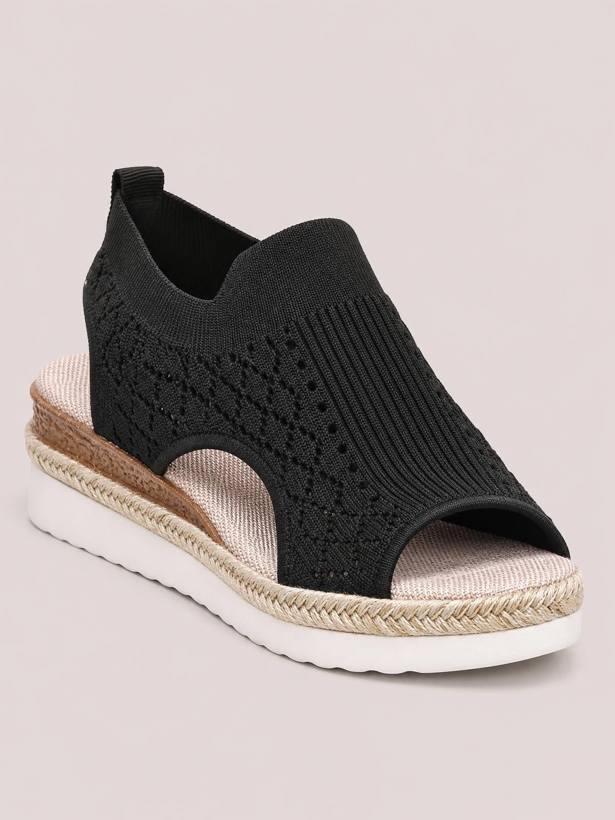 Black mesh open toe platform wedge sandal with a mid-height heel, textured cutout sides, woven trim, and a cushioned white rubber sole.