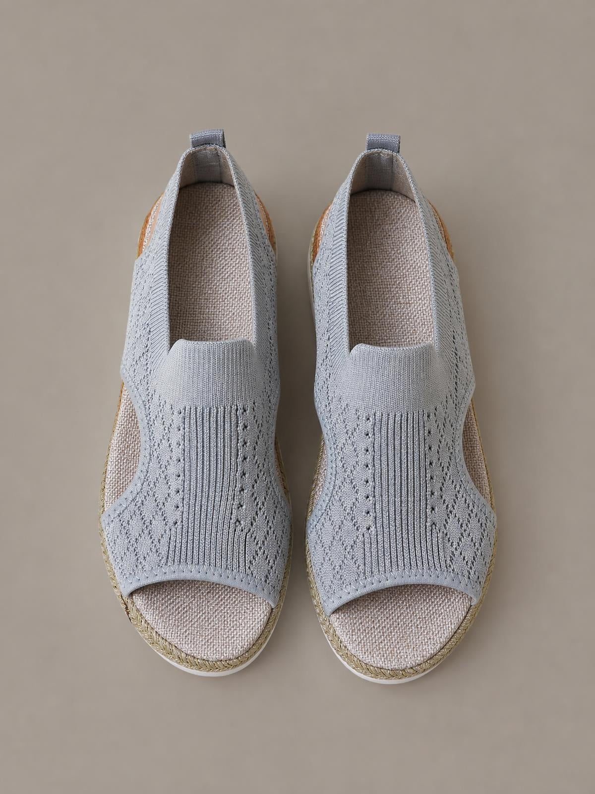 Light gray open toe platform wedge sandals feature textured mesh uppers, enclosed sides, cushioned footbeds, and woven mid-height wedge soles.