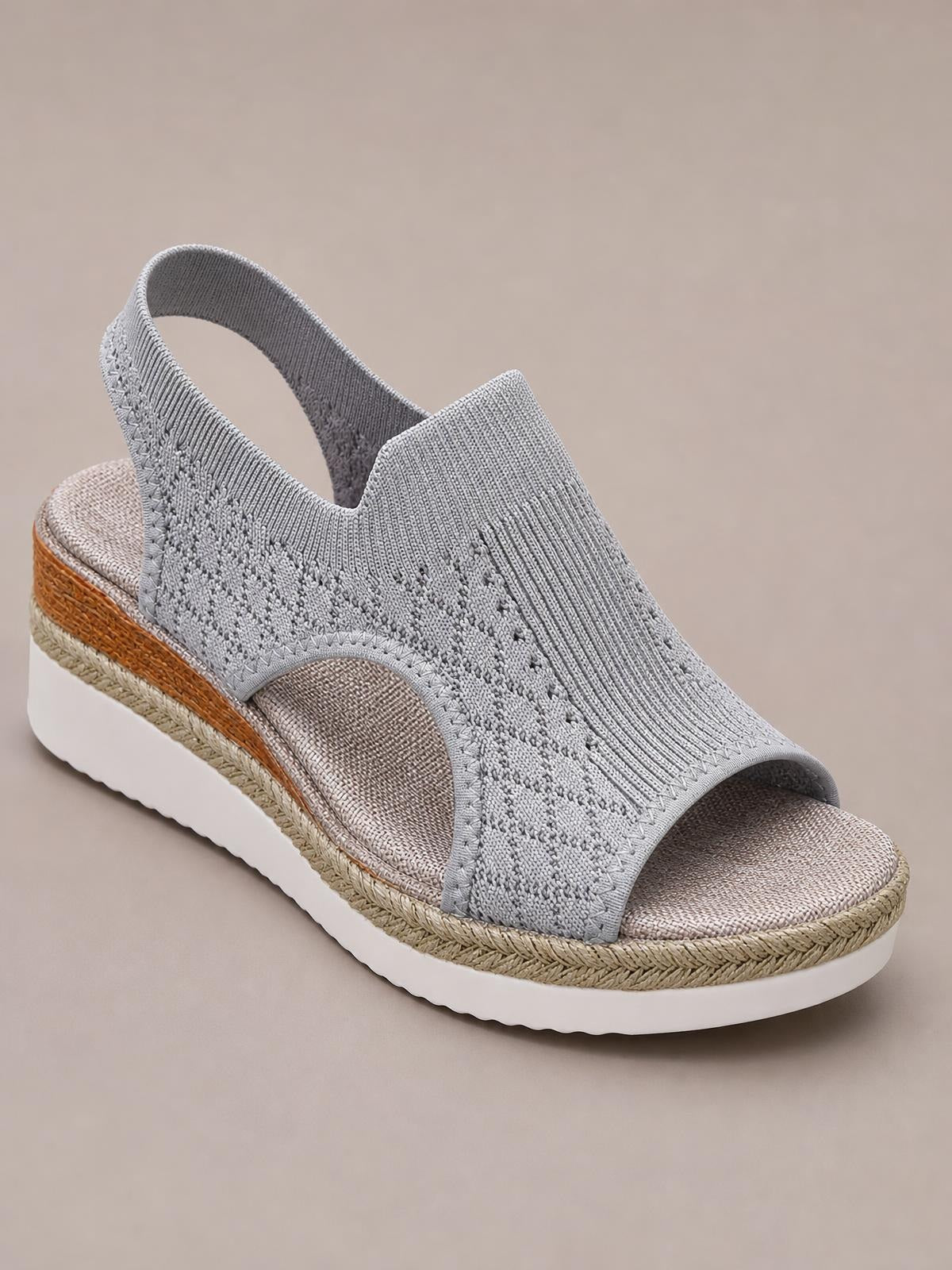 Gray mesh open toe platform wedge sandal with a wide textured upper, slingback strap, cushioned footbed, and braided mid-heel sole.