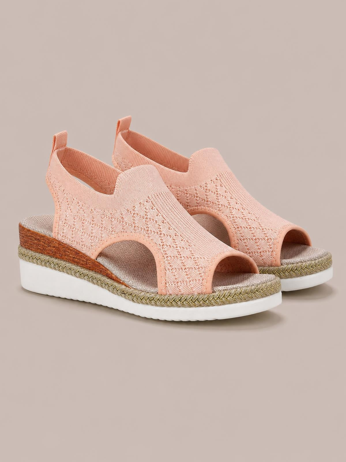 Peach mesh open toe platform wedge sandals feature side cutouts, mid-height wedges, braided trim, and thick white rubber soles.