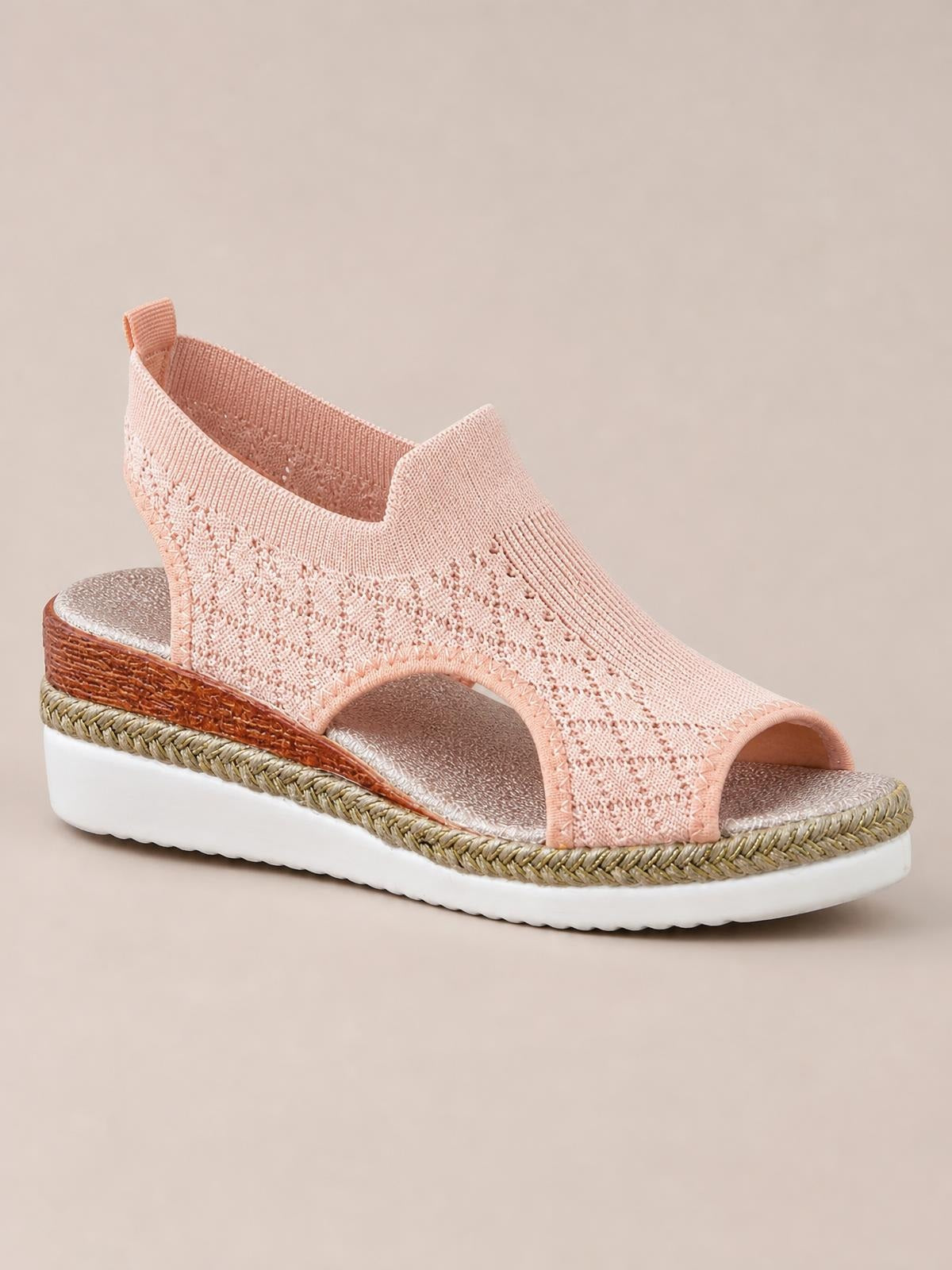 Pink mesh open-toe platform wedge sandal with a closed heel, woven trim, mid-height wedge, and white rubber sole.