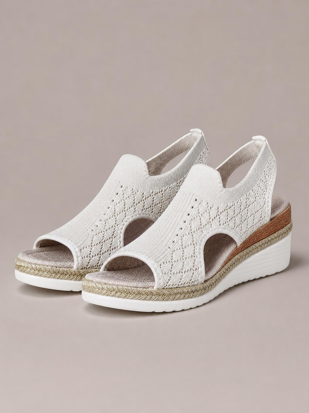 White open toe platform wedge sandals feature breathable mesh uppers, side cutouts, braided trim, mid-height wedges, and cushioned rubber soles.