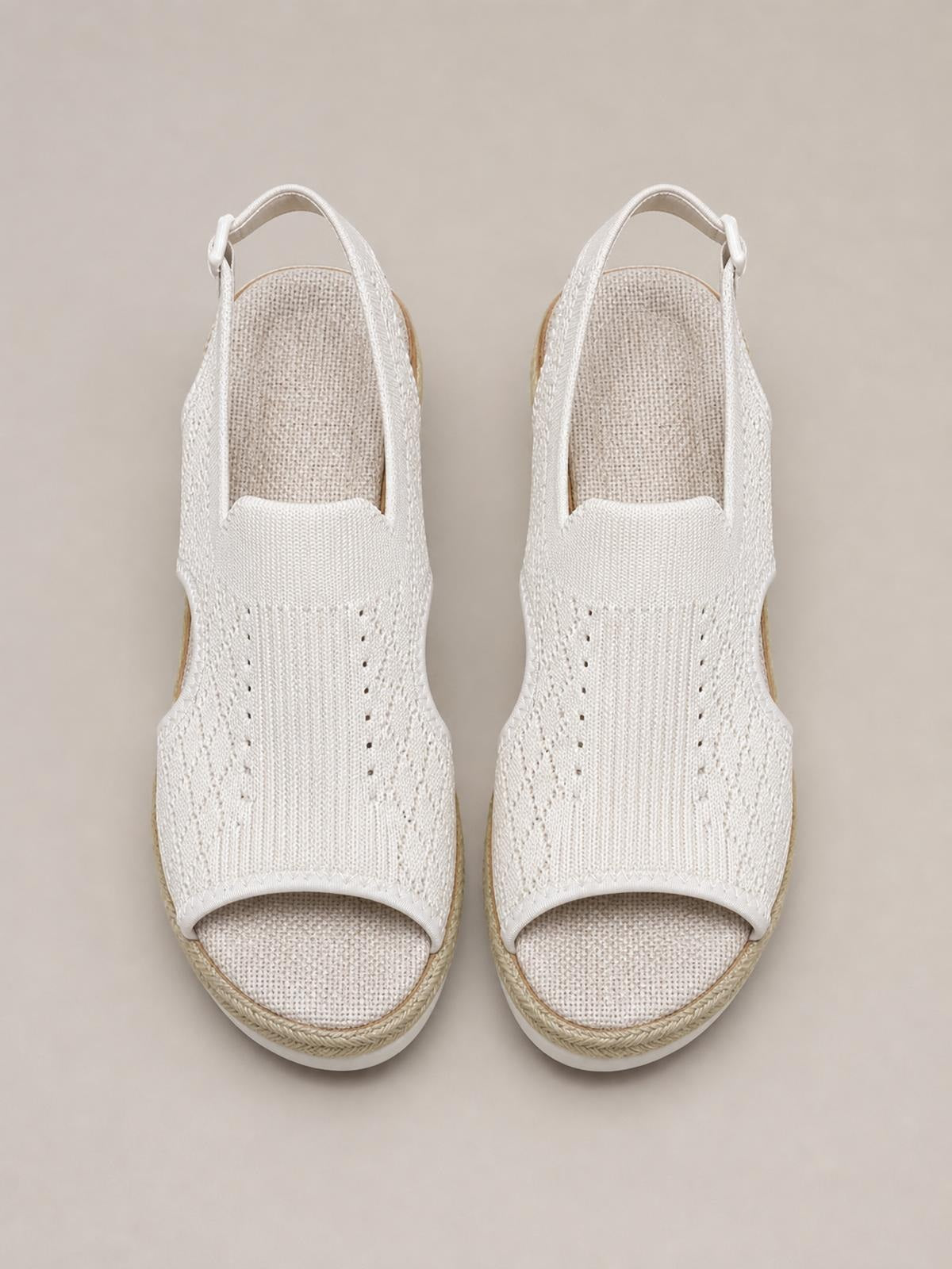 White open-toe platform wedge sandals feature textured mesh uppers, ankle straps, covered toes, and mid-height espadrille-style wedge soles.