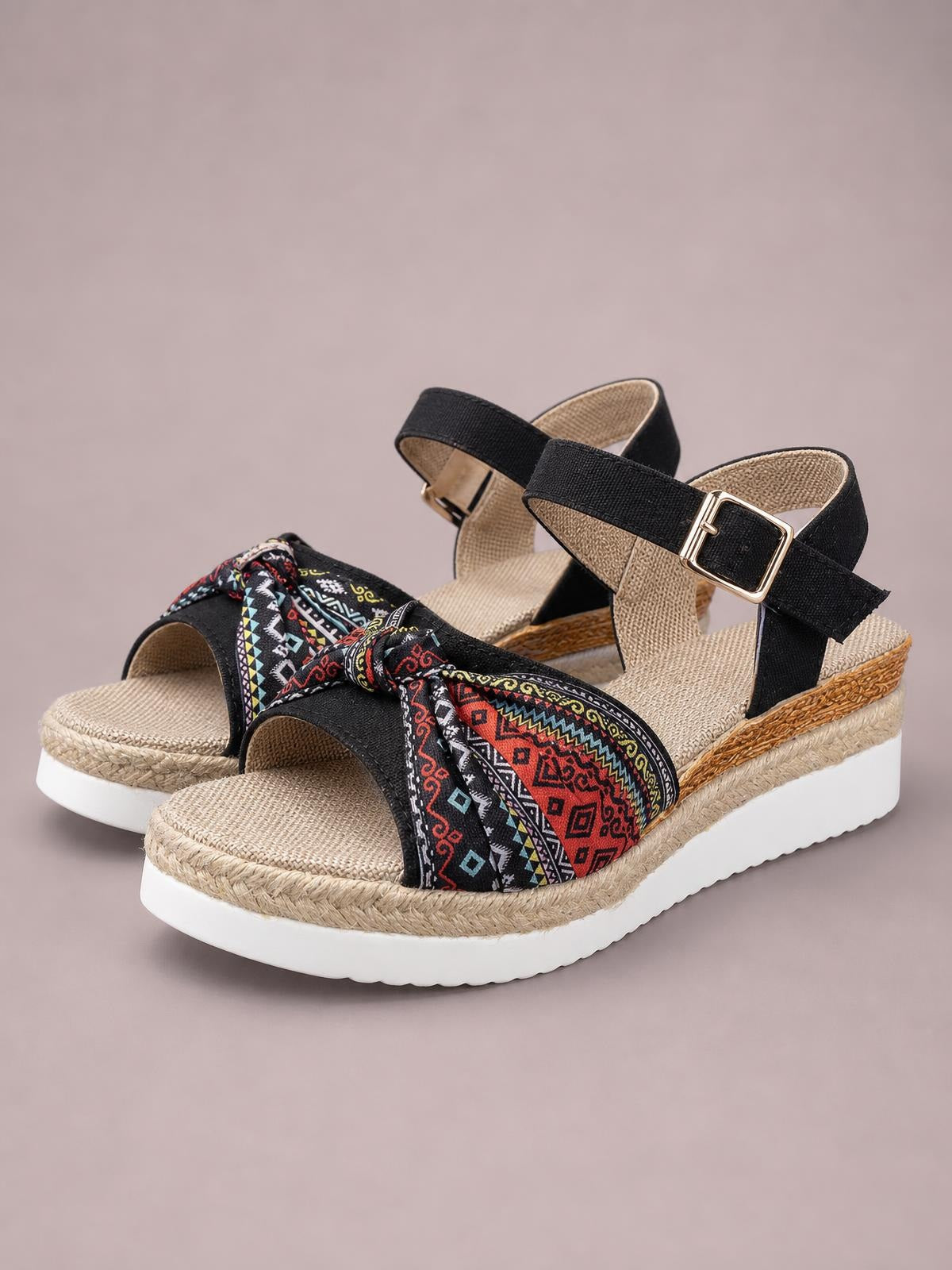 Black open toe platform wedge sandals feature colorful patterned fabric straps, ankle buckle closures, woven espadrille trim, and a comfortable mid-height heel.